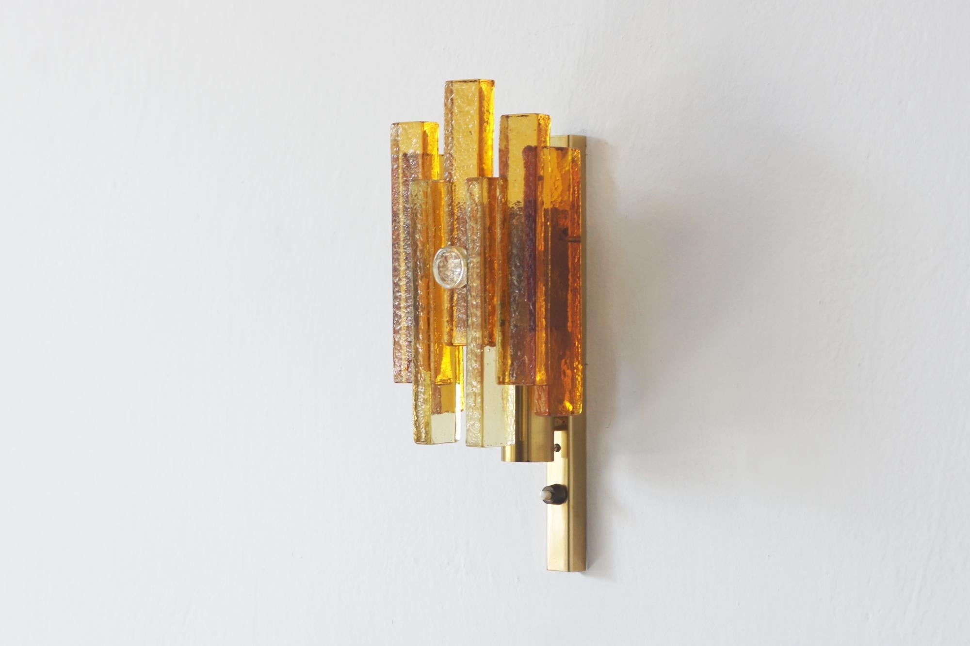 A rare and elegant wall lamp designed by Svend Aage Holm-Sørensen, one of Denmark's leading lighting designers of the mid-century modern era. Holm-Sørensen became famous for skillfully combining Scandinavian functionalism with decorative finesse -