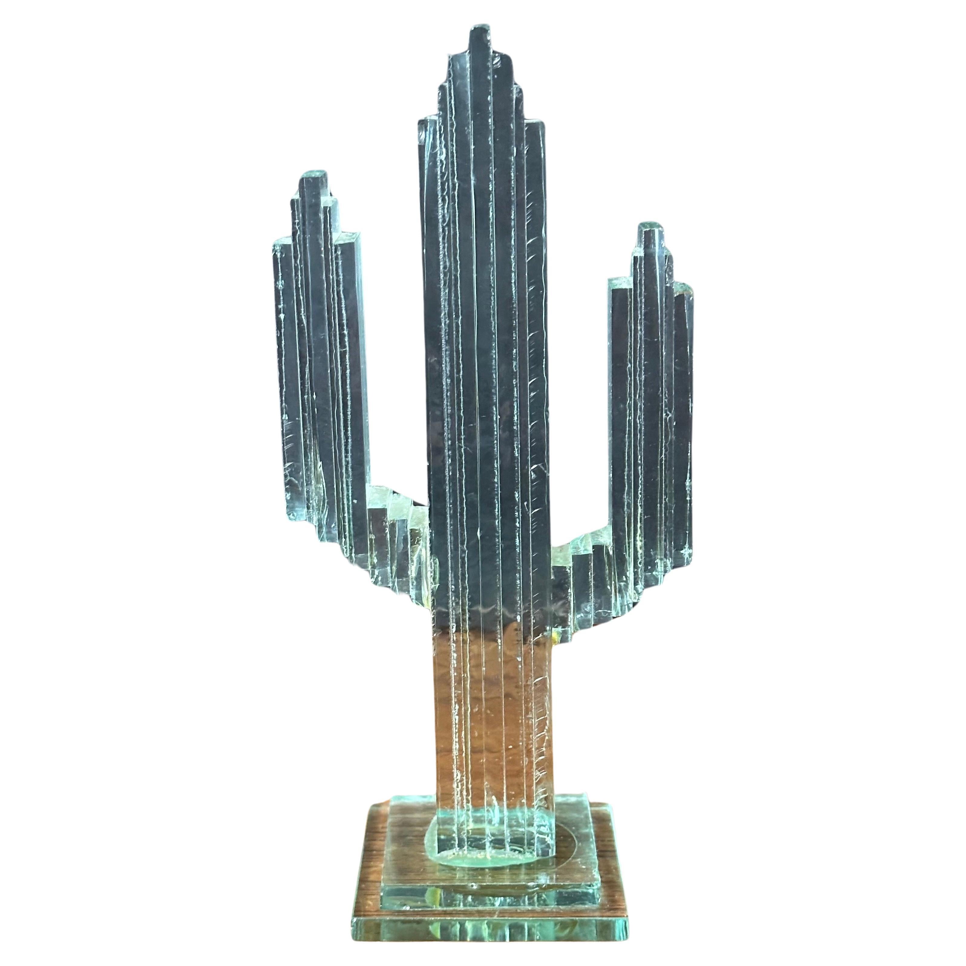 A very cool stacked glass panel saguaro cactus sculpture, circa 1980s.   The piece is hand made by gluing stacked panels of glass, it is in very good condition with bo chips or cracks and measures 3.75