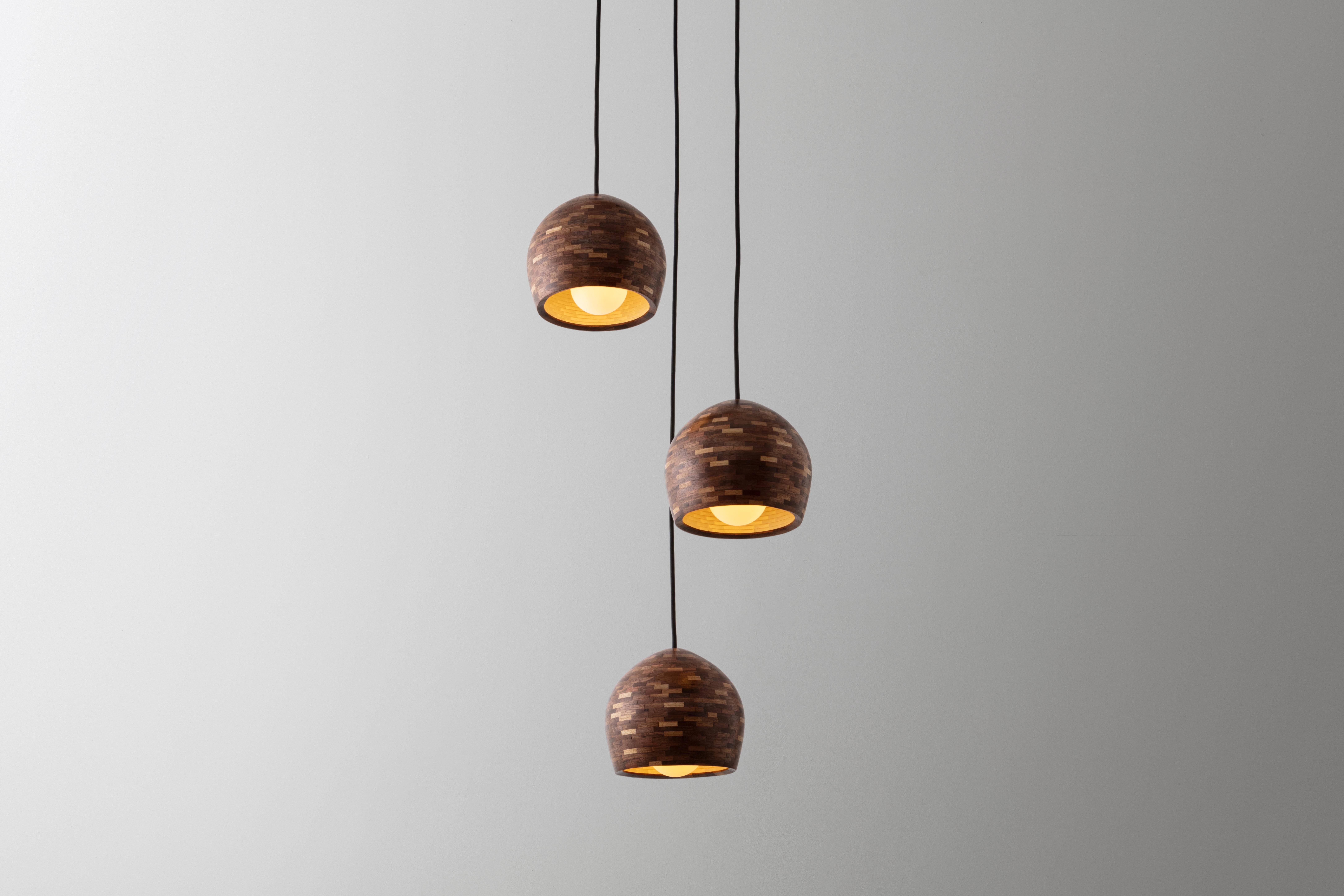 These medium-sized STACKED Ostrich egg-shaped pendants shown here are made of salvaged Walnut. All pendants are hand-built custom per your specifications. Larger or smaller, used individually or as a grouping, a different profile or a different