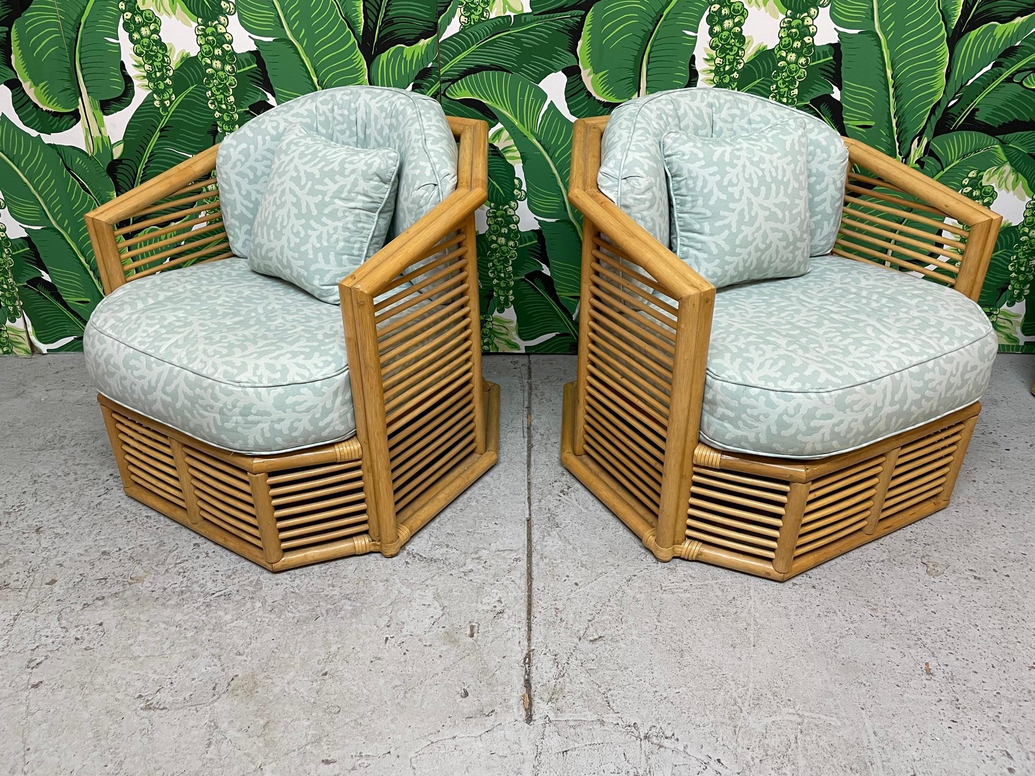 Pair of vintage rattan club chairs feature stacked horizontal fretwork in the manner of Franco Albini. Sculptural frame that flares at base. Very good condition with only very minor imperfections consistent with age.