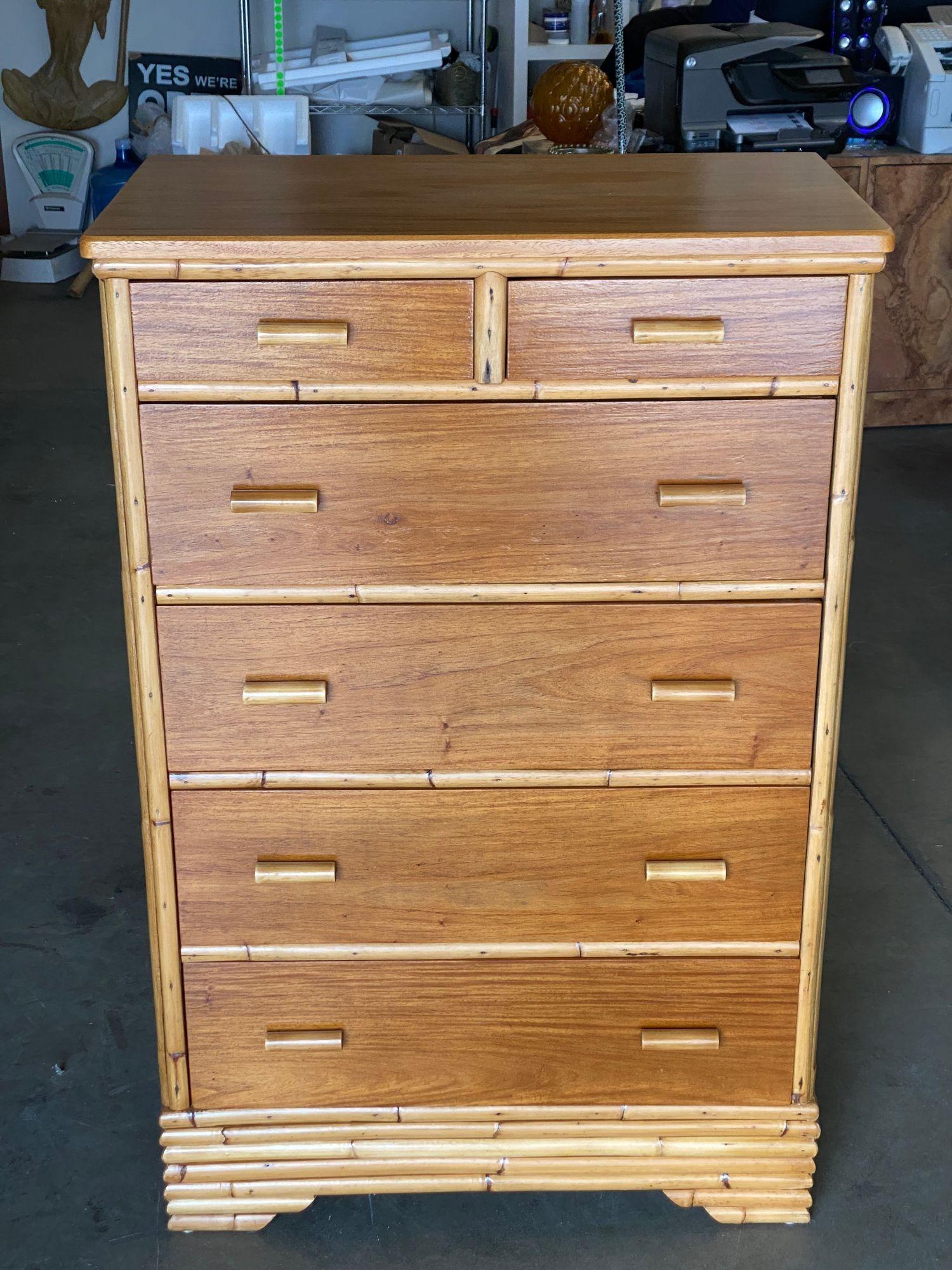 Stacked rattan Highboy dresser with a mahogany top and five pull-out drawers. circa 1970. Stacked rattan and mahogany bedroom set with a set of two bedside tables and one highboy dresser.  Dimensions: 48
