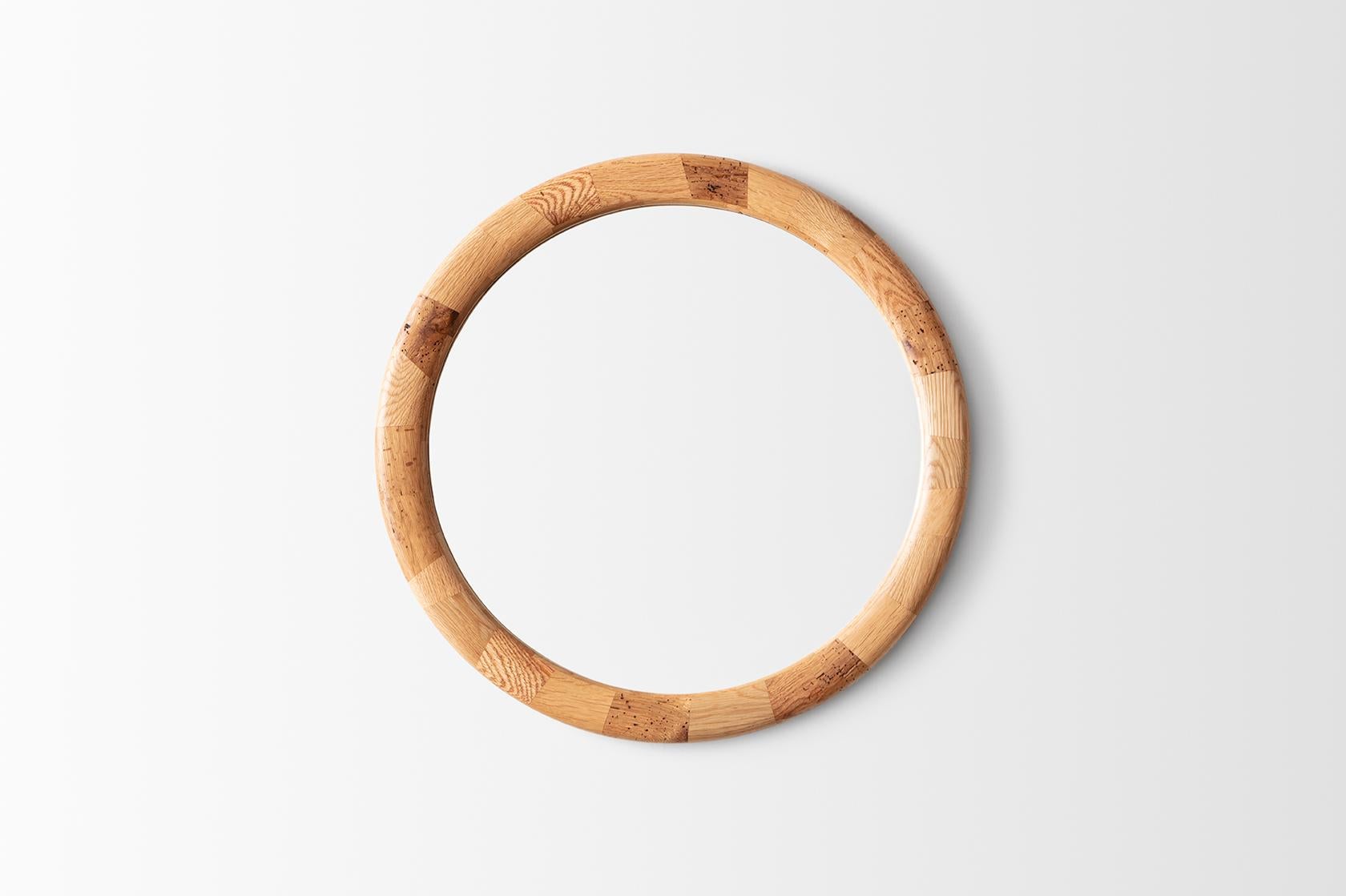 This mirror’s STACKED Round Frame has been hand-built from salvaged Oak. Made from tiny blocks of wood; each block has been carefully placed to create the desired shape. Once built, the surface gets gently sculpted smooth using a variety of hand