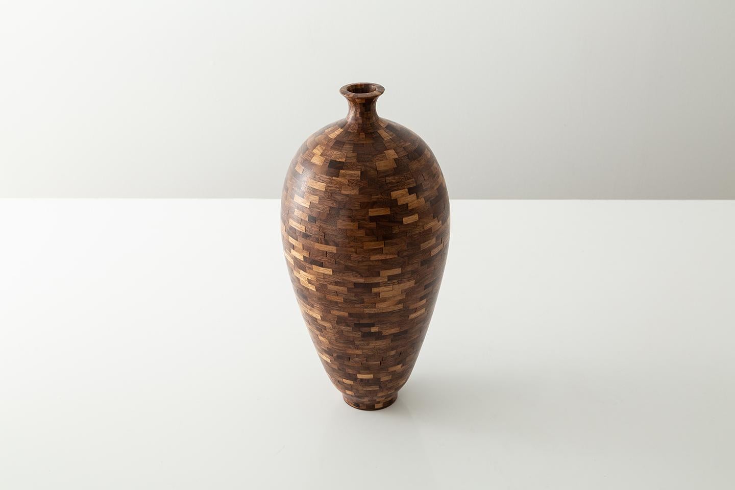 Part of Richard Haining's STACKED Collection, this spherical vase is made from reclaimed walnut. The reclaimed walnut was sourced and salvaged from a variety of local Brooklyn wood shops. The wood's natural coloring shows off tones primarily ranging