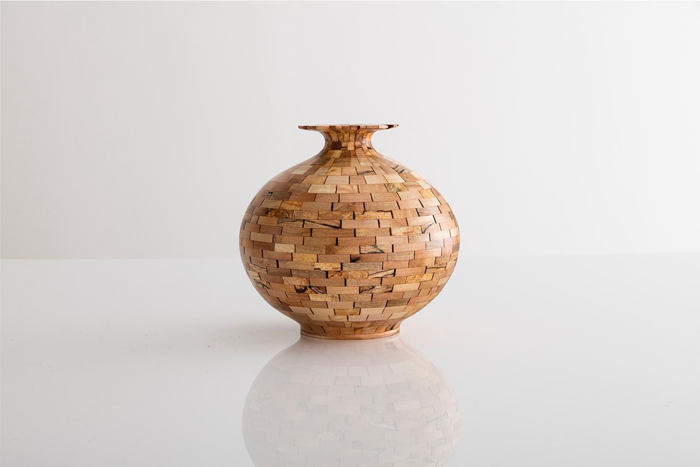 Part of Richard Haining's STACKED Collection, this vase was made using reclaimed California redwood salvaged from a decommissioned NYC water tower. The wood's natural coloring shows off tones ranging from pink and deep reds to almost black in color.