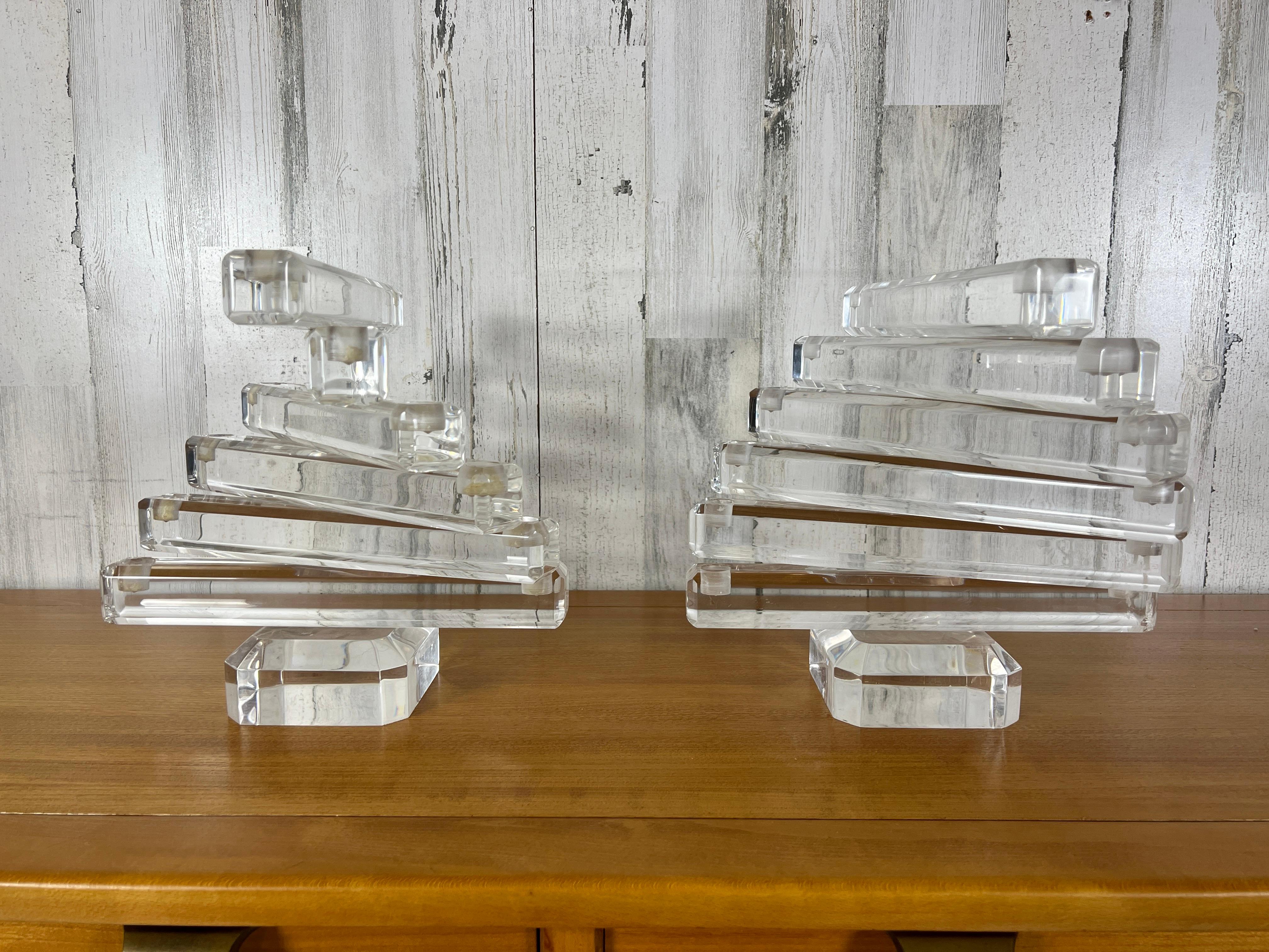 Mesmerizing stacked spiral lucite candelabras. Can be used property as candelabras or as decorative objects.