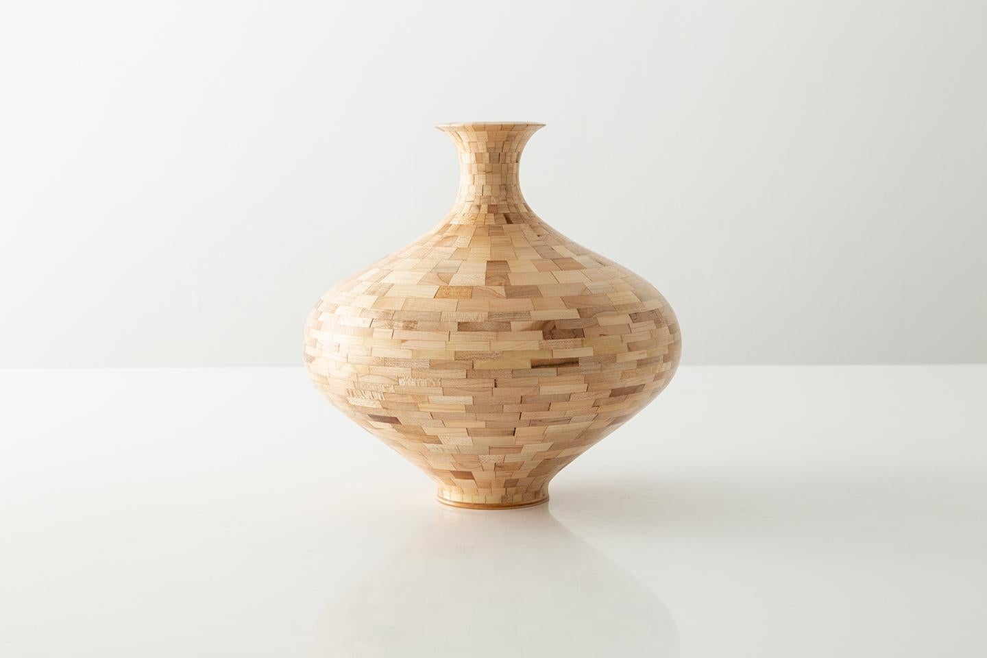 Part of Richard Haining's STACKED Collection, this spherical vase is made from reclaimed maple. The salvaged wood offcuts were sourced from a variety of local Brooklyn wood shops. The salvaged wood's natural coloring shows off tones ranging from