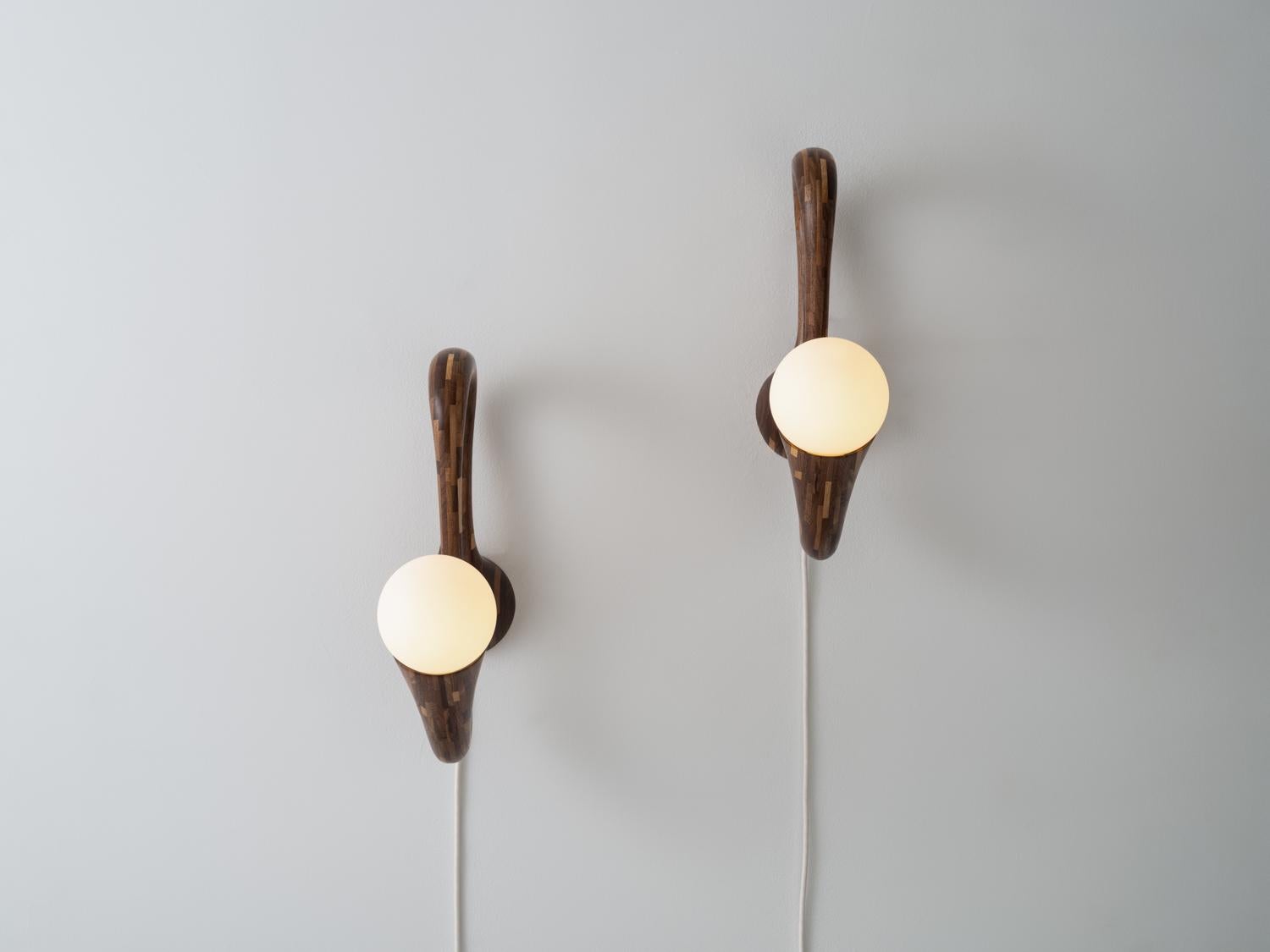 This pair of identical twin STACKED Sconces are made of salvaged Walnut.

The beauty of Richard’s signature STACKED style is based entirely in the process. These Sconces, made of Salvaged Walnut feature Tala's Porcelain III LED Lightbulbs. As with