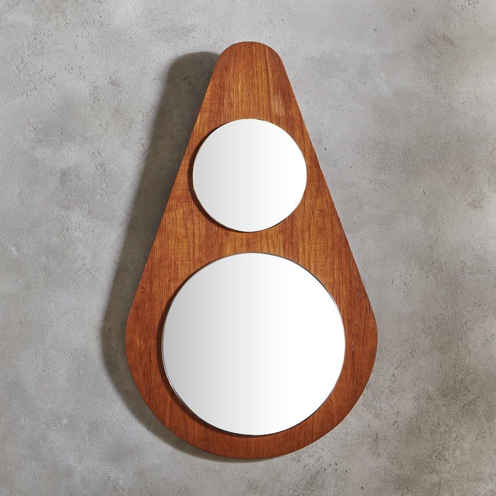 A 1970s Italian mirror featuring a teardrop shaped wood frame with a rich chestnut stain. The frame supports two stacked circular mirrors with a beveled edge. It has a wooden backing and hardware for hanging. Unmarked. Sourced in Italy, 1970s. 

