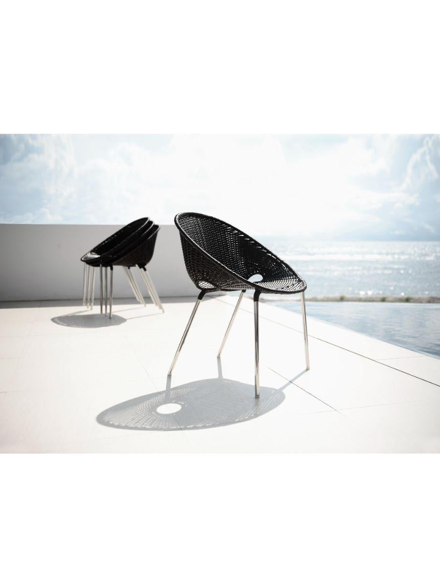 Stacking armchair by Kenneth Cobonpue
Materials: Polyethylene, steel, stainless steel.
Dimensions: 60cm x 60cm x 76cm 

The signature dents in the Dimple armchair add a subtle cheekiness to an outdoor space. Stacks up to three chairs. Made of