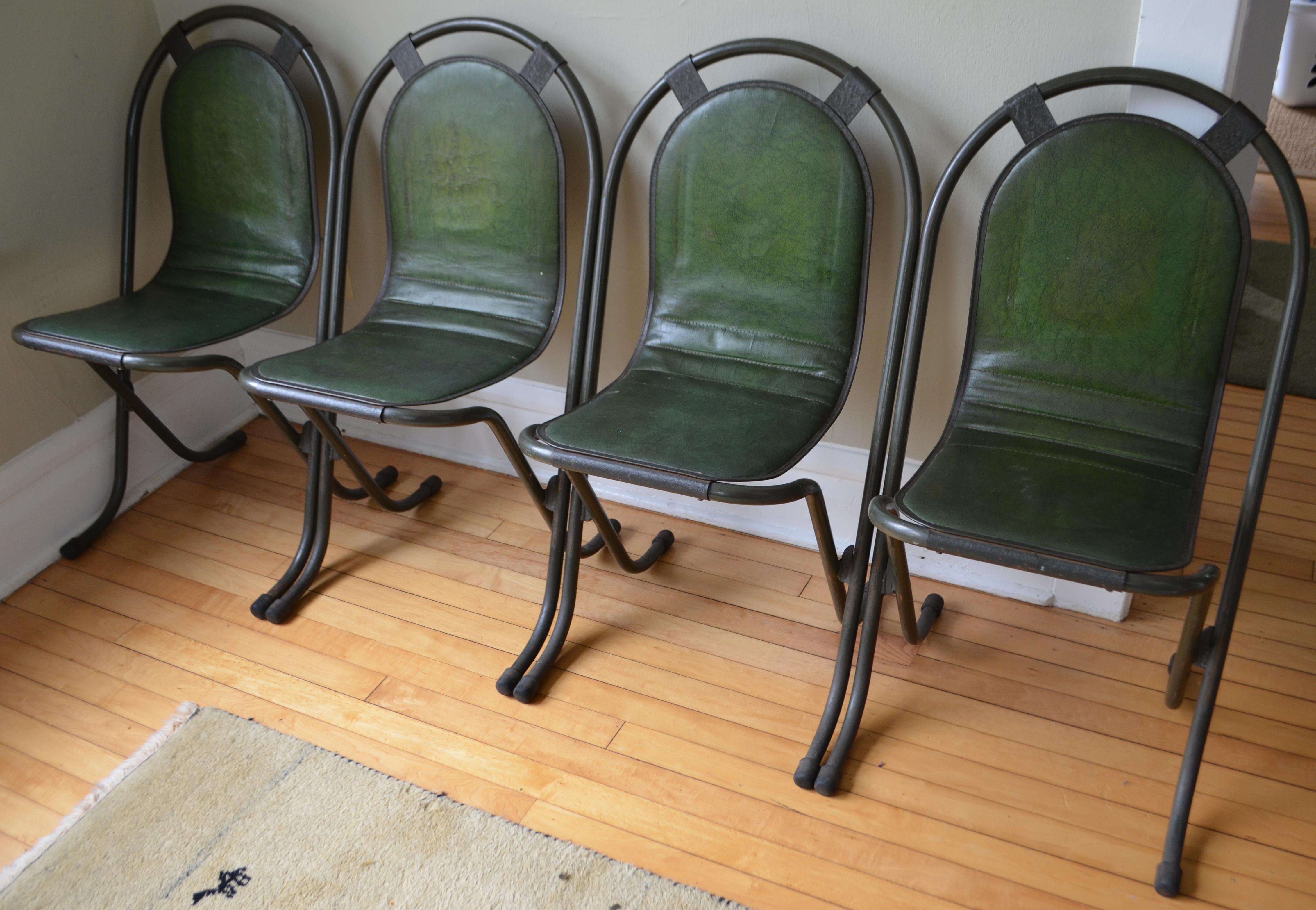 Original Stak-a-Bye chairs from Sebel of England, circa 1940. Set of 4. Padded green faux leather covers pressed metal seat and back mounted on a tubular steel frame. Legs capped in rubber feet. Debuted in 1947 when the war-weary English had finally