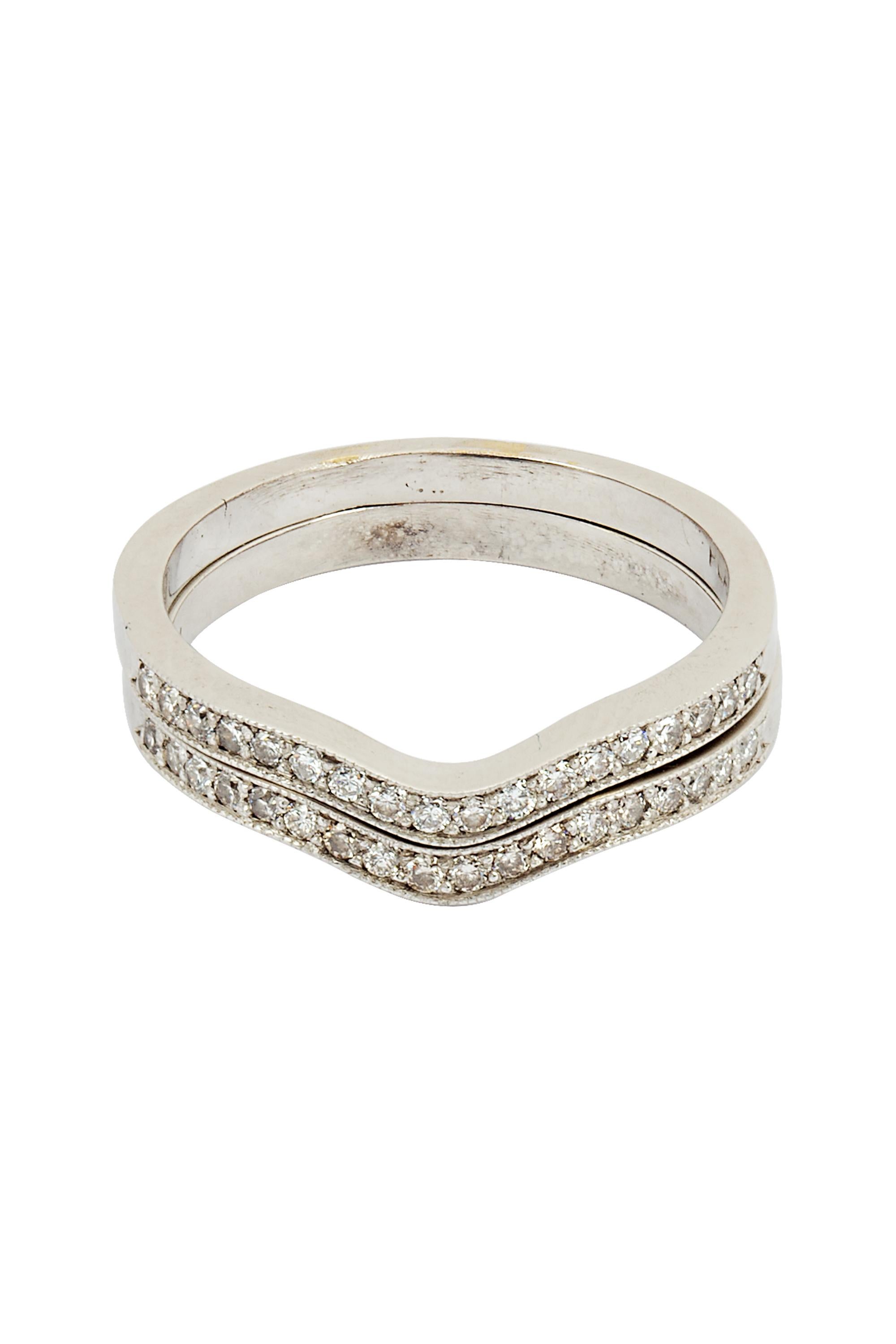Two vintage stacking chevron shaped bands crafted in platinum and each set with a center ribbon of 18 round diamonds. The two bands have a total diamond weight of approximately .70 carats. Ring size 7 ½.

