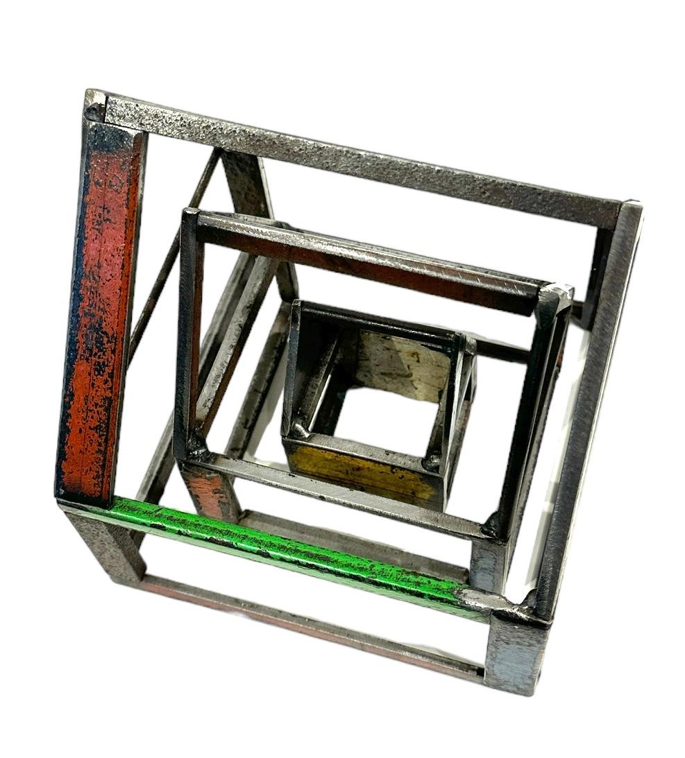 This is a welded steel sculpture made by furniture creator Jim Rose. It is sustainable design created from salvaged and recycled steel panels left over from his larger projects. These sculptures reference traditional American Folk Art barn house