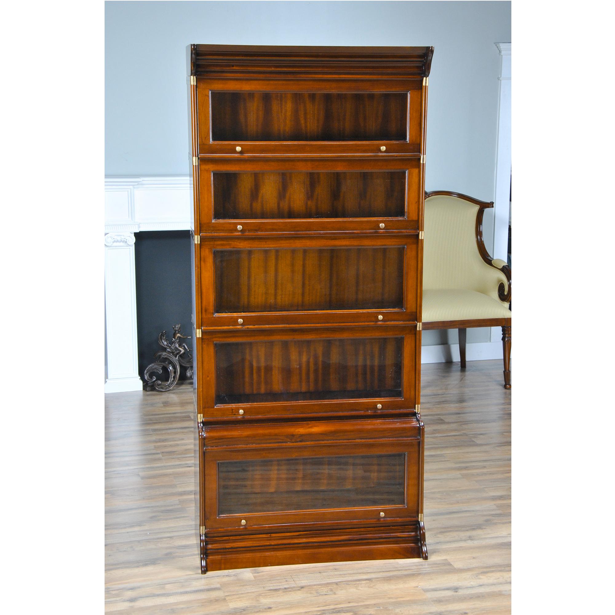 This excellent quality Stacking Mahogany Bookcase or barrister bookcase consists of seven separate pieces: a cap, a base and five glass sections. The oversized atlas sized base section is a real bonus for all the larger texts in your collection. The