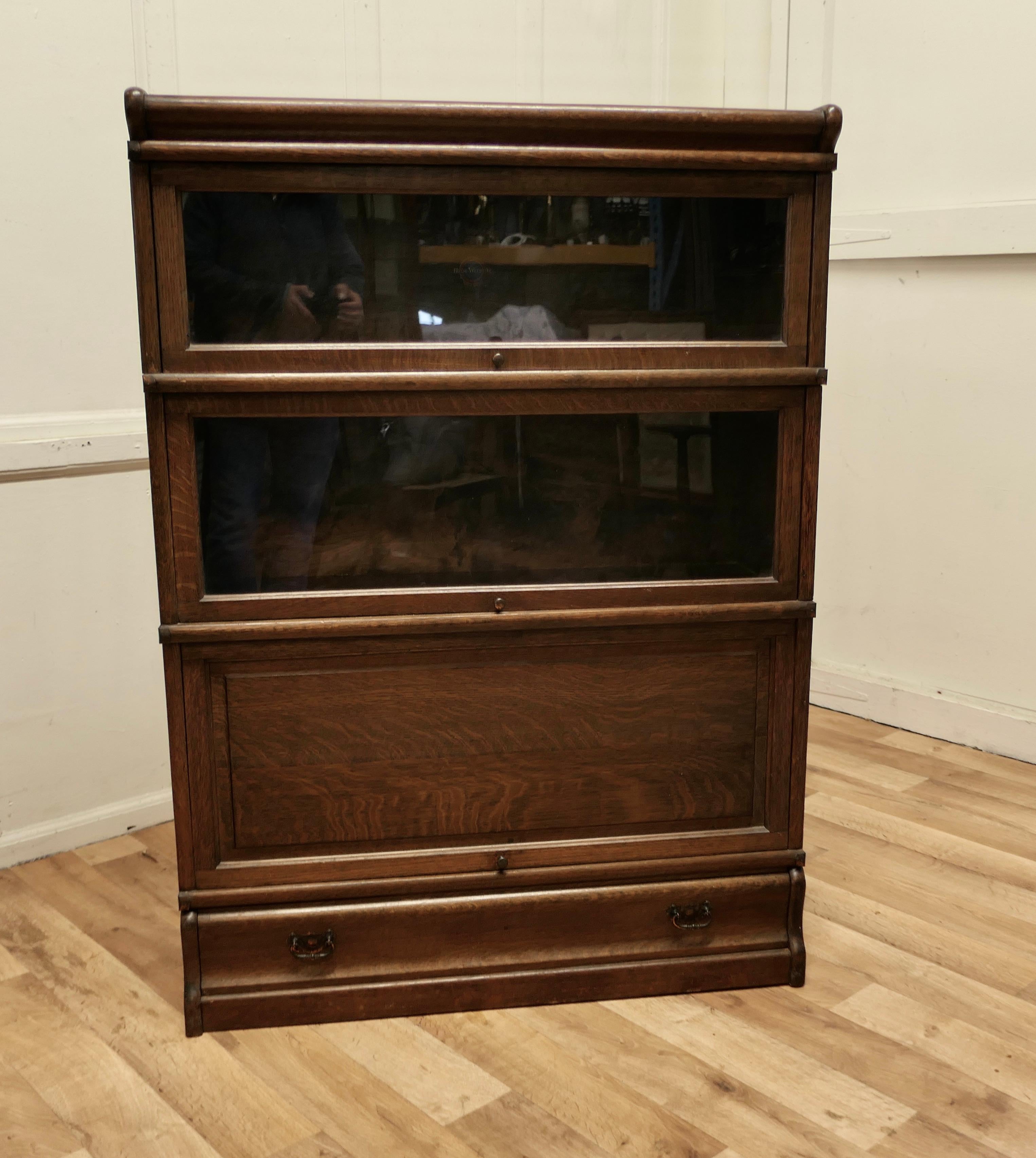 Stacking oak globe Wernicke barristers bookcase or filing cabinet.

This is a good quality bookcase, all of the sections have a copper side banding, the bookcase has a shallow cornice at the top, 2 glazed, sections, one oak panelled section and a
