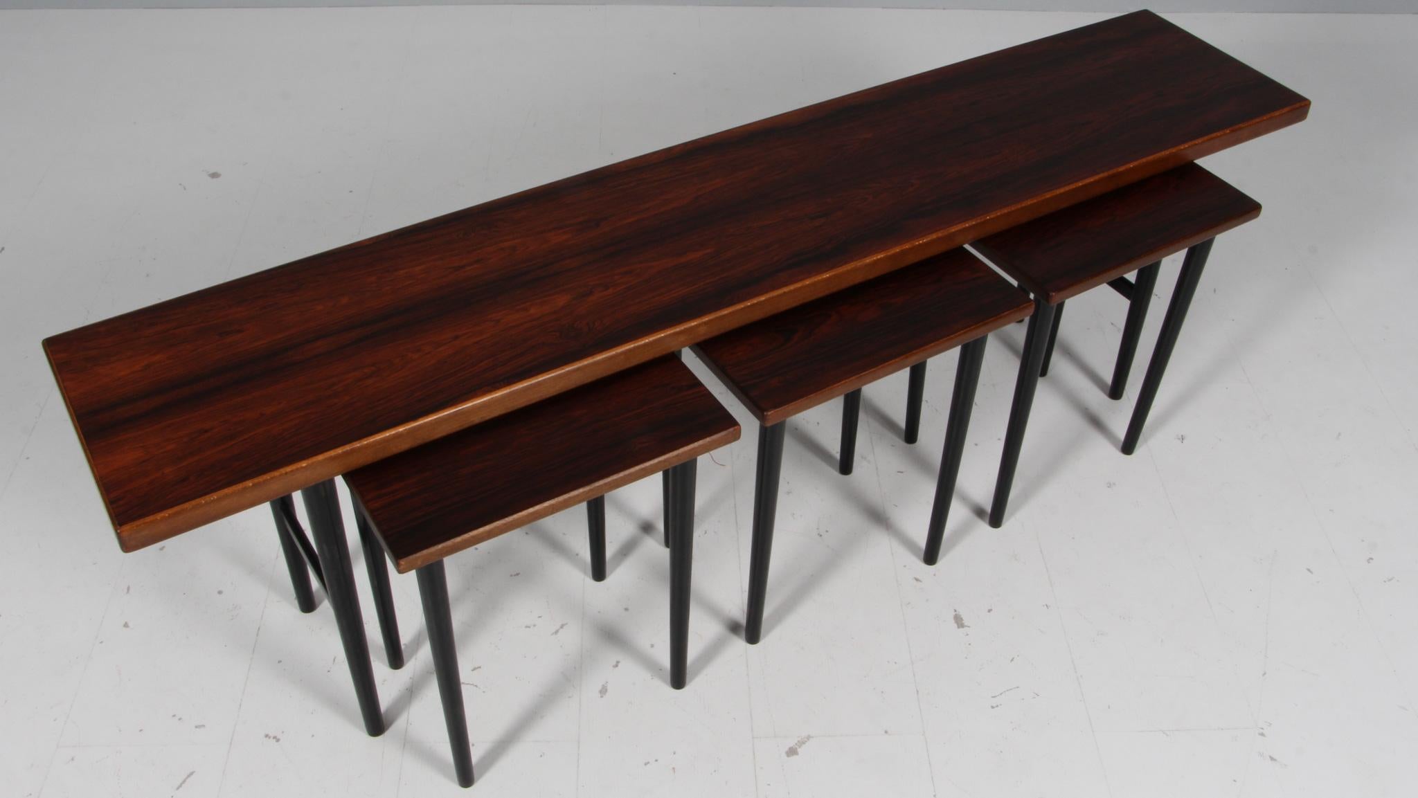 Kurt Østervig stacking table in rosewood.

Legs of black lacquered wood.

Made by Jason.