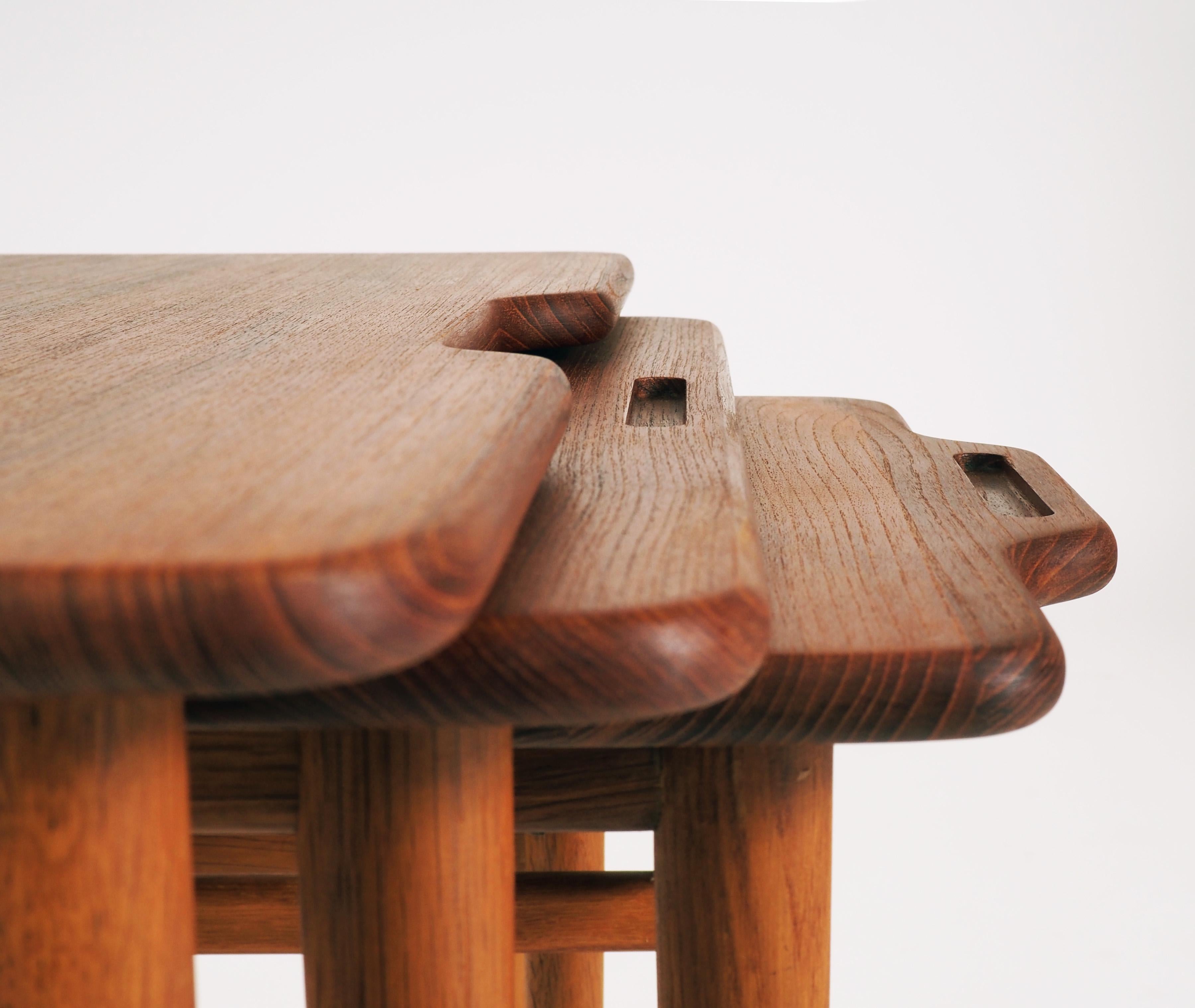 Stacking tables with tops in massive teak and legs in oak. Beautiful handle details. Designed by the Danish architect Kurt Östervig and produced by Jason, Ringsted, Denmark. Labelled with 