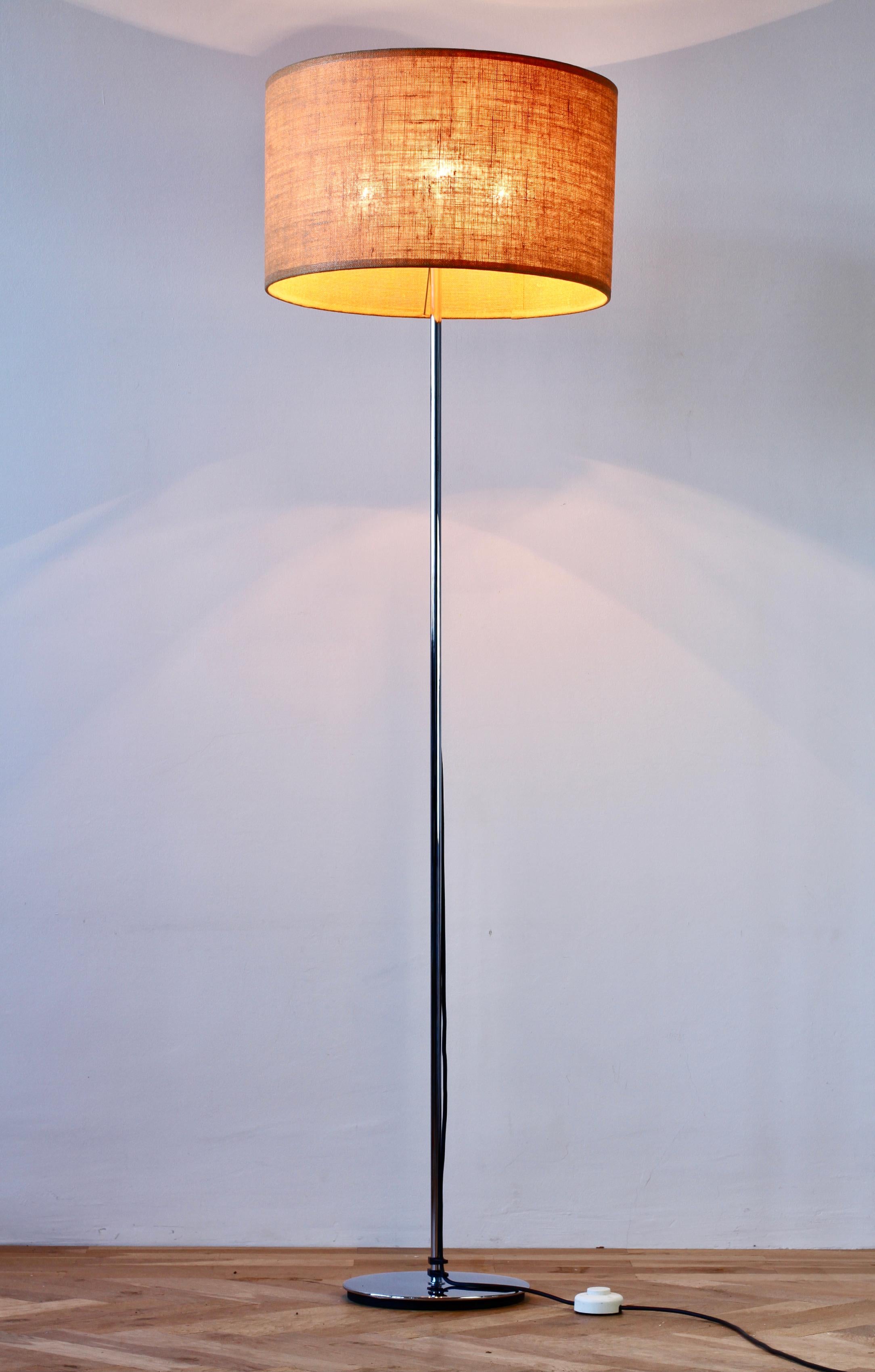 Mid-Century Modern vintage German floor lamp made by Staff Leuchten circa 1970s and is in excellent vintage condition. Made of polished chrome plated metal, the original woven fabric lamp shade is height adjustable making this the perfect modernist