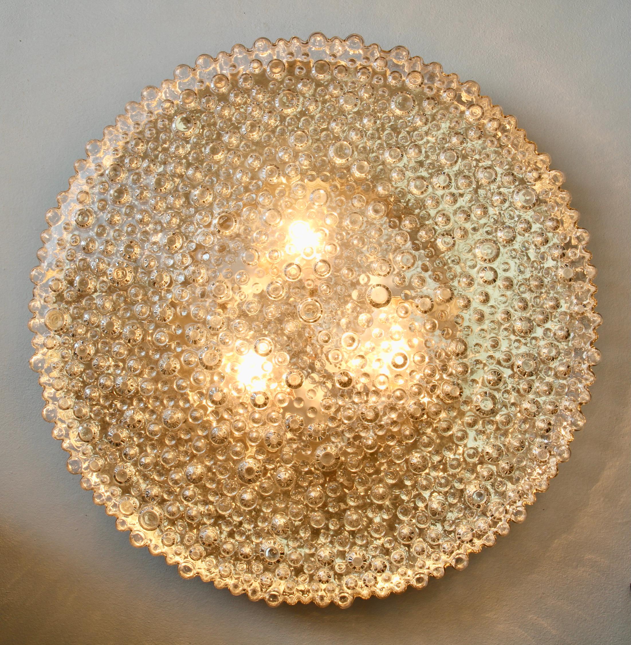 A beautiful and extra large 50cm (nearly 20 inch) vintage mid-century modern flush mount light fixture by German lighting manufacturer Staff Leuchten, circa 1970s. Featuring a wonderful mouth blown, molded and textured clear glass shade resembling