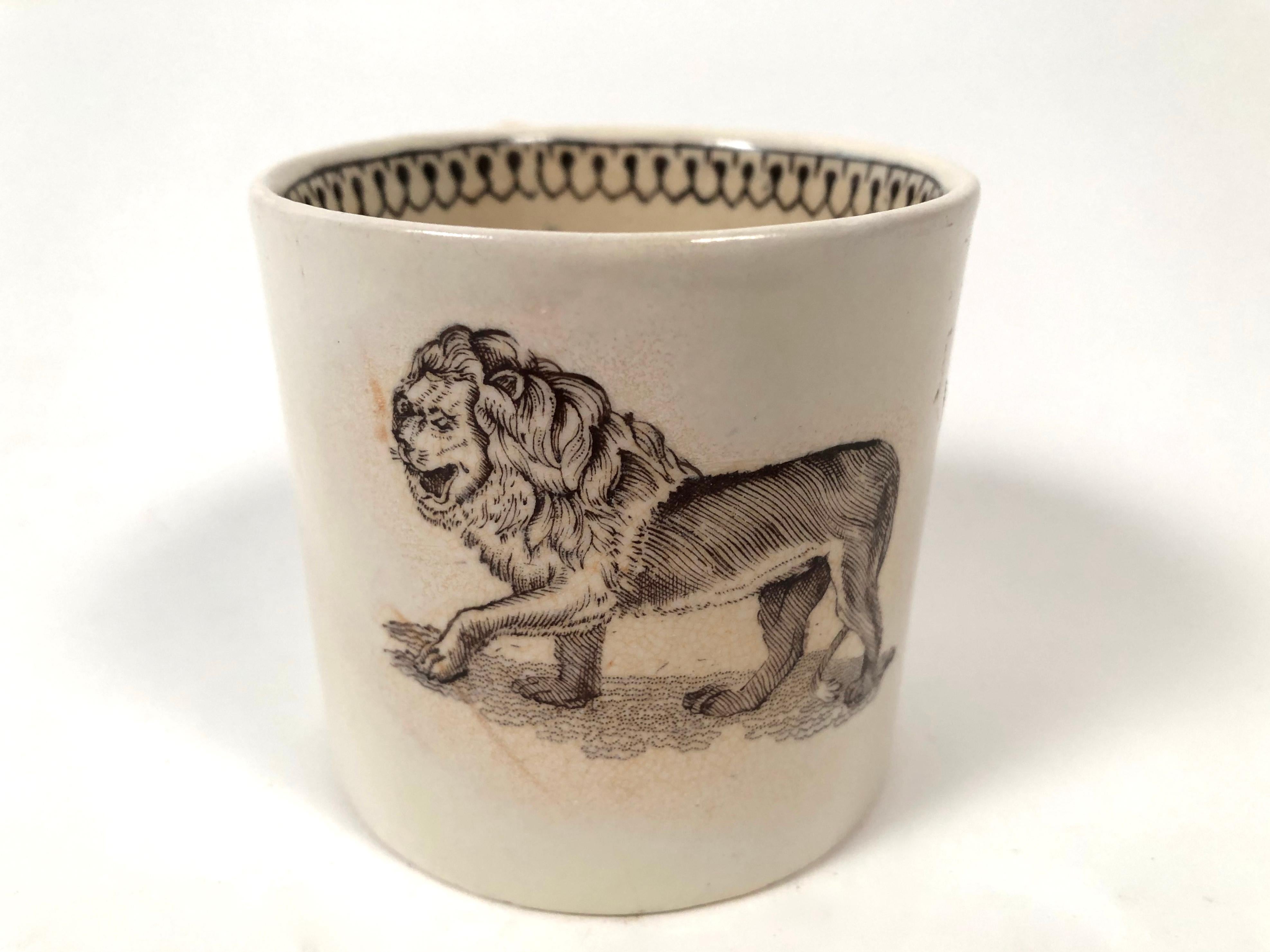 A charming 19th century English Staffordshire pottery brown transferware child size mug with an image of a striding lion on the exterior and a geometric band on the interior rim, circa 1810. Perfect for the Leo or lion lover in your life.
