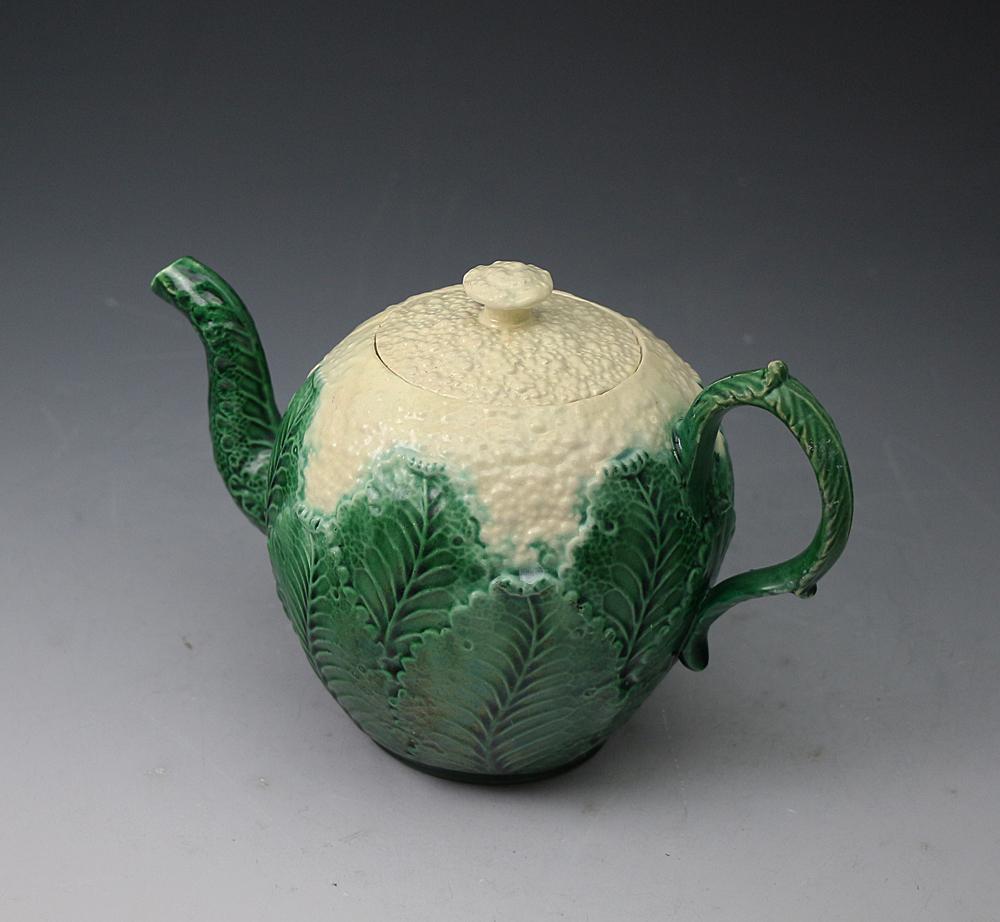 Mid-18th century relief modeled Staffordshire pottery teapot with a creamware body in the form of a cauliflower with a green and cream lead glaze. Wedgwood-Whieldon type, such examples are strongly collected and are increasingly rare.