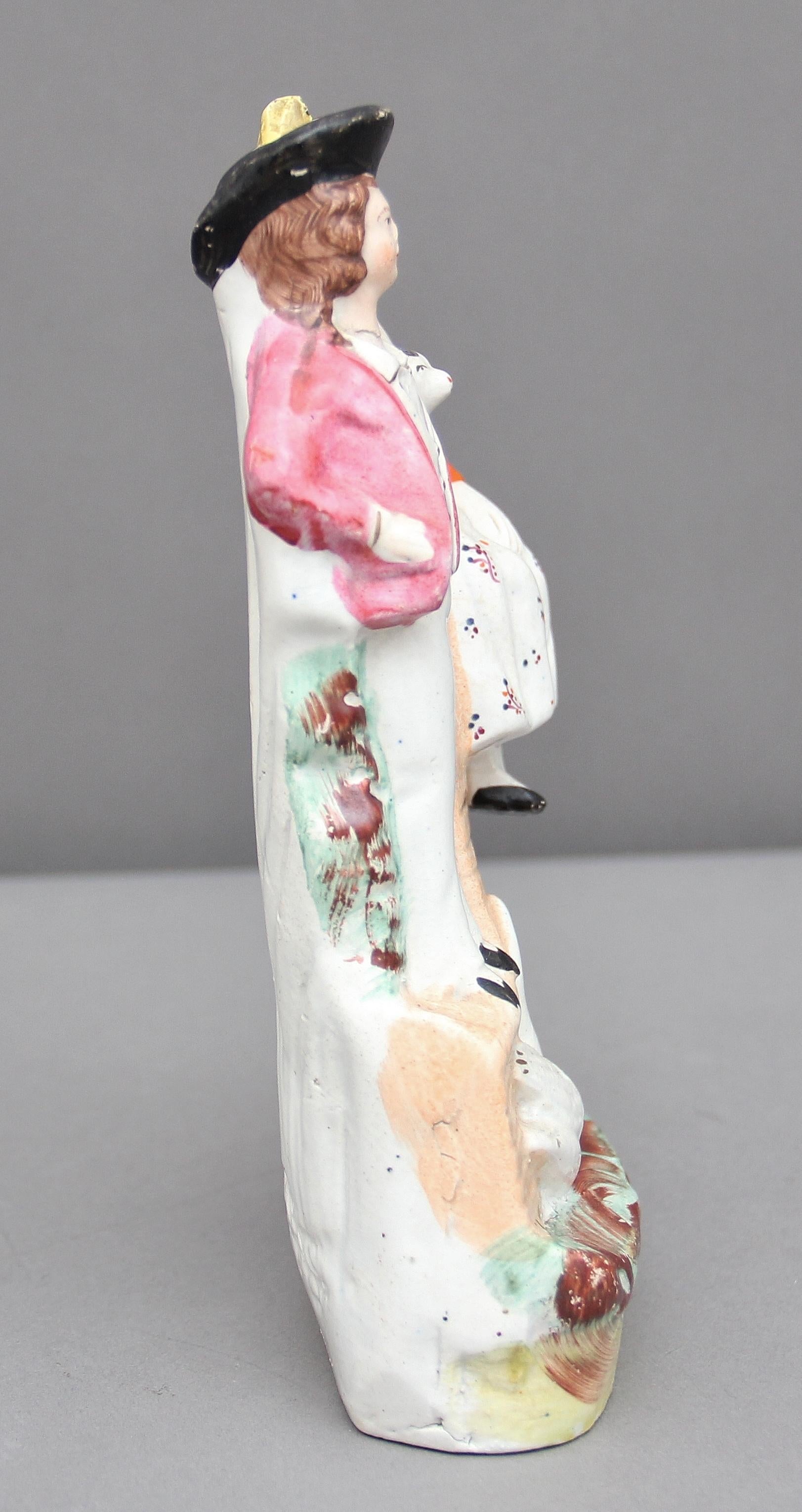 19th century Staffordshire figure of a man and woman, the woman sitting on a bridge with a dog, a swan at their feet. Good color and condition, circa 1860.