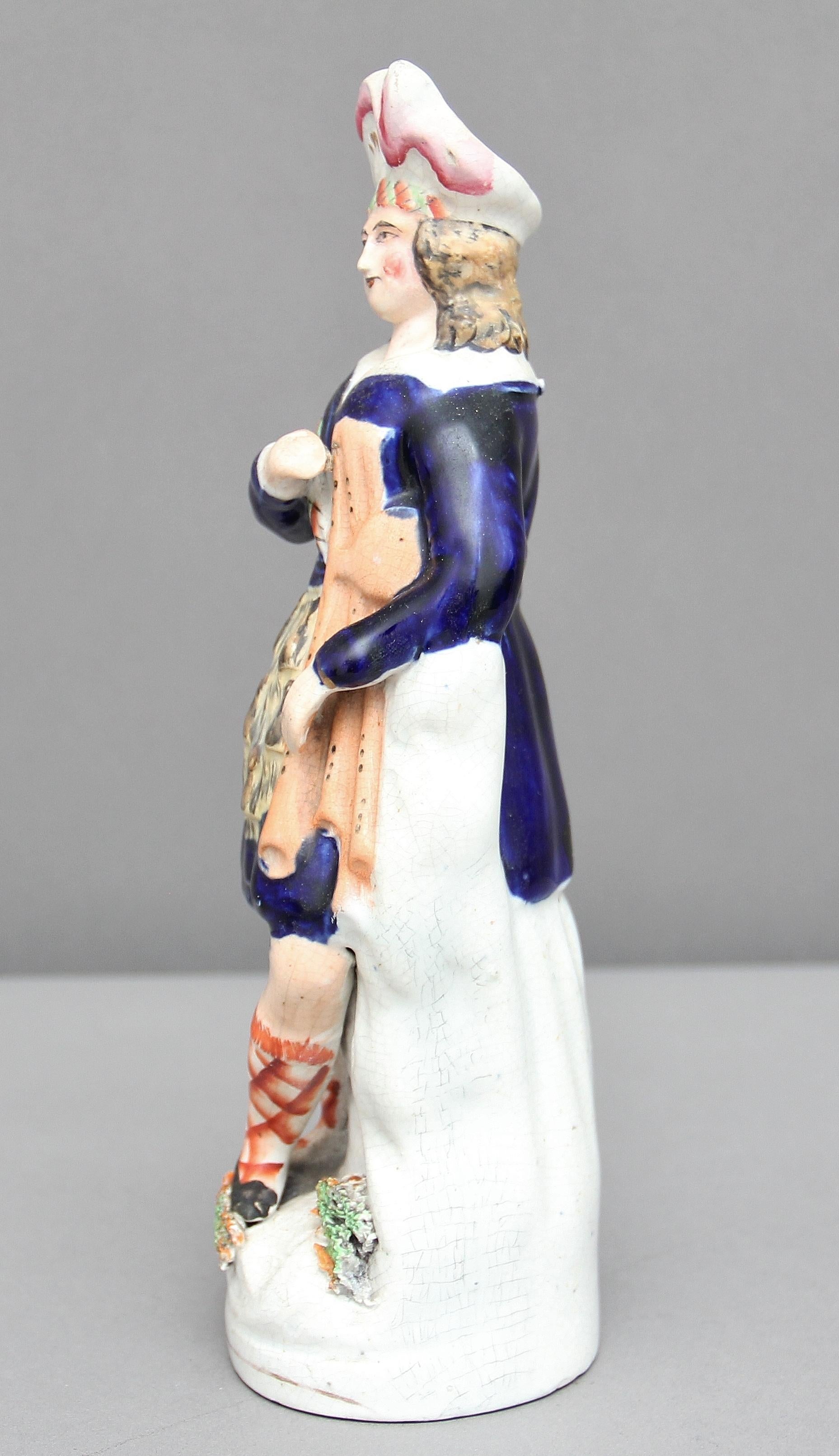 19th century Staffordshire figure of a Scottish piper holding his bagpipes. God color and condition, circa 1850.