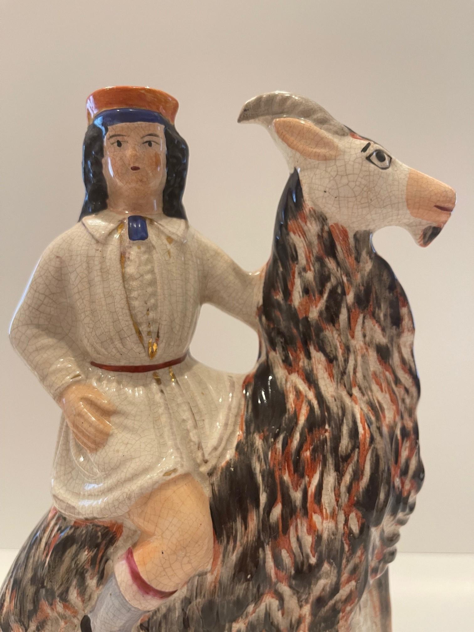 Hard to find Staffordshire figure of a young boy on a goat. This would have originally been part of a pair, the other being a young girl on a goat