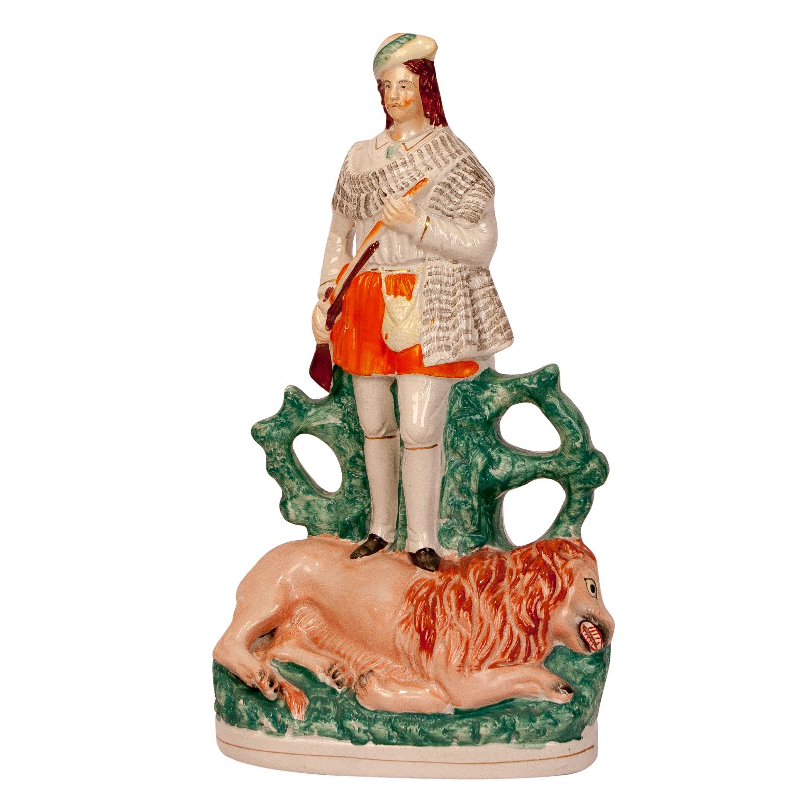A large-scale English Staffordshire figure of a Scotch Hunter standing atop a lion, circa 1860.