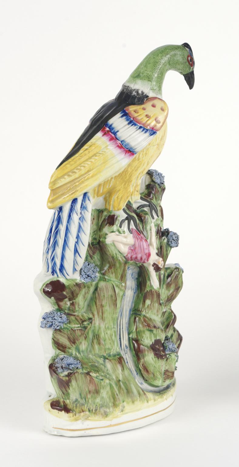 Staffordshire figure, depicting an enormous brightly painted bird dangling a woman over a waterfall.

It has been suggested the subject of this harrowing group is the fabled Roc bird of 
