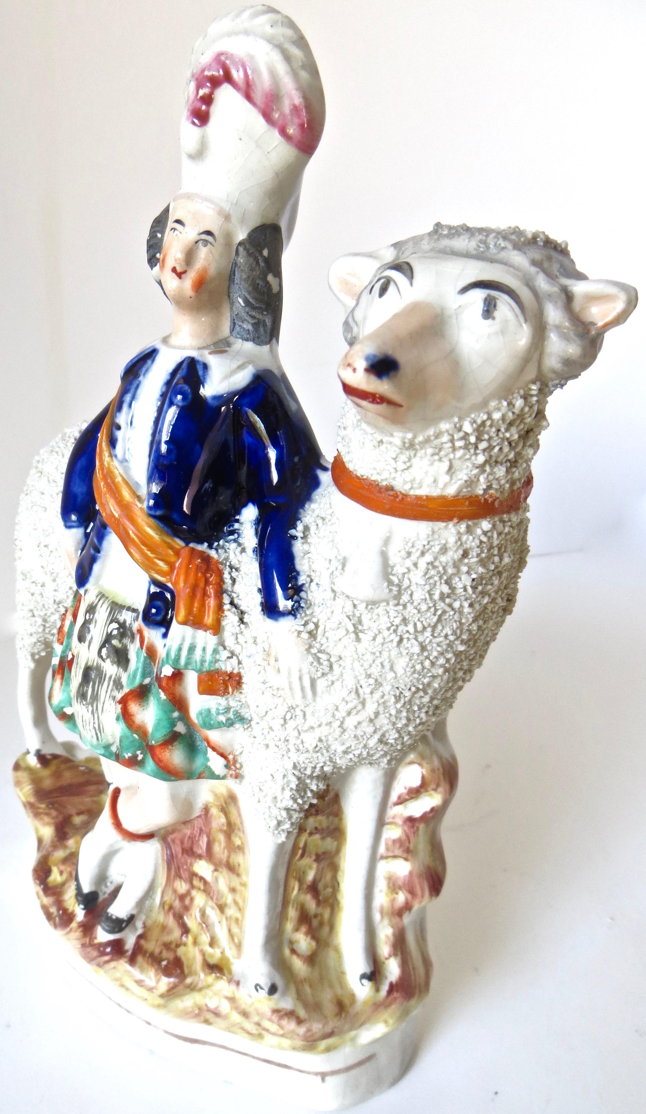 Mid-19th Century Staffordshire porcelain figurine depicts a Scotitsh highlander young boy standing next to an oversized sheep. He is dressed in typical formal garb wearing a green, white, and orange kilt; a navy blue jacket and a formal feathered