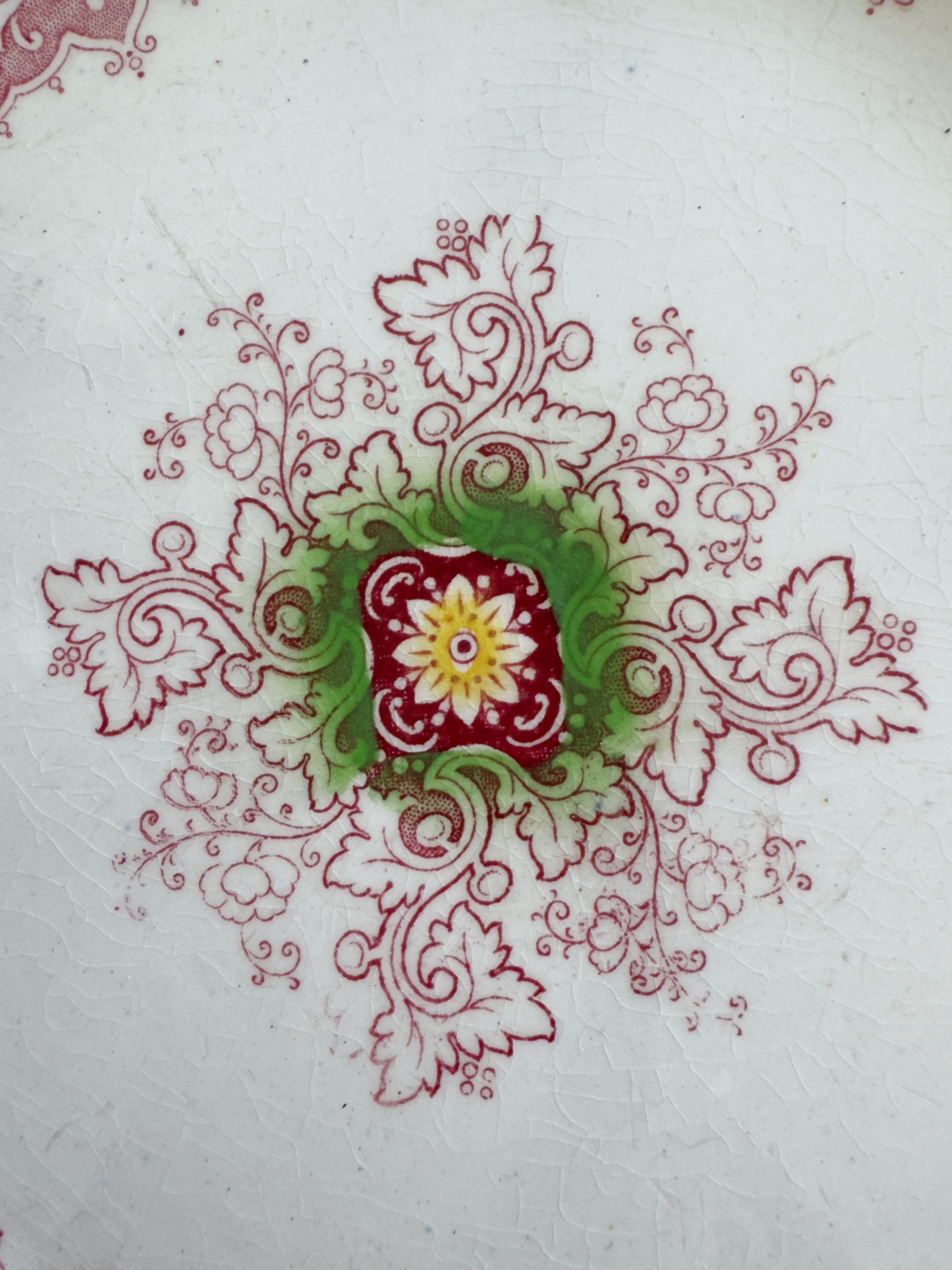 This exquisite ironstone plate by Francis Morley & Co. of Staffordshire features the intricate Zamara pattern in a rich deep pink, accented with touches of blue, green, and yellow. With its distinctive twelve sided shape, this piece dates between