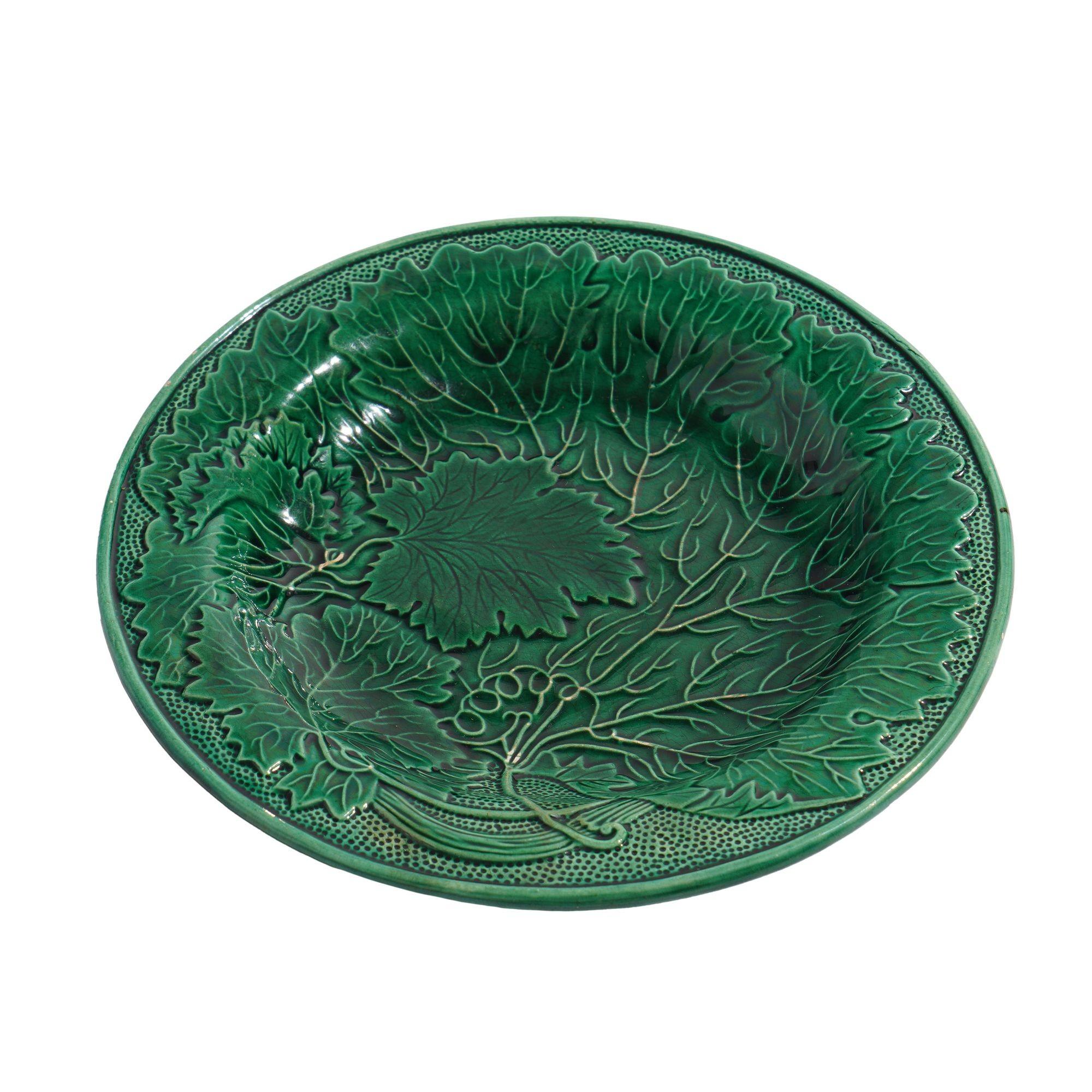 Green glazed majolica tea plate with grape leaf impressed surface. Unmarked.
Staffordshire, England, circa 1840.