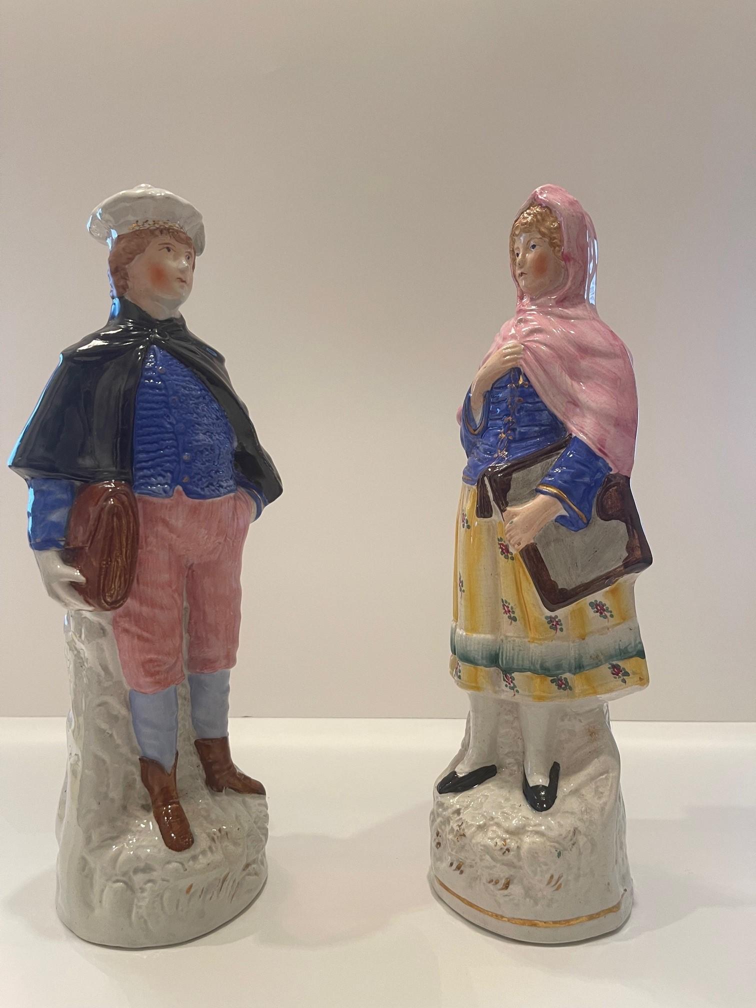 A pair of late Staffordshire figures of a School Boy carrying a satchel, and a girl carrying a book, Circa: 1870 Size: 12