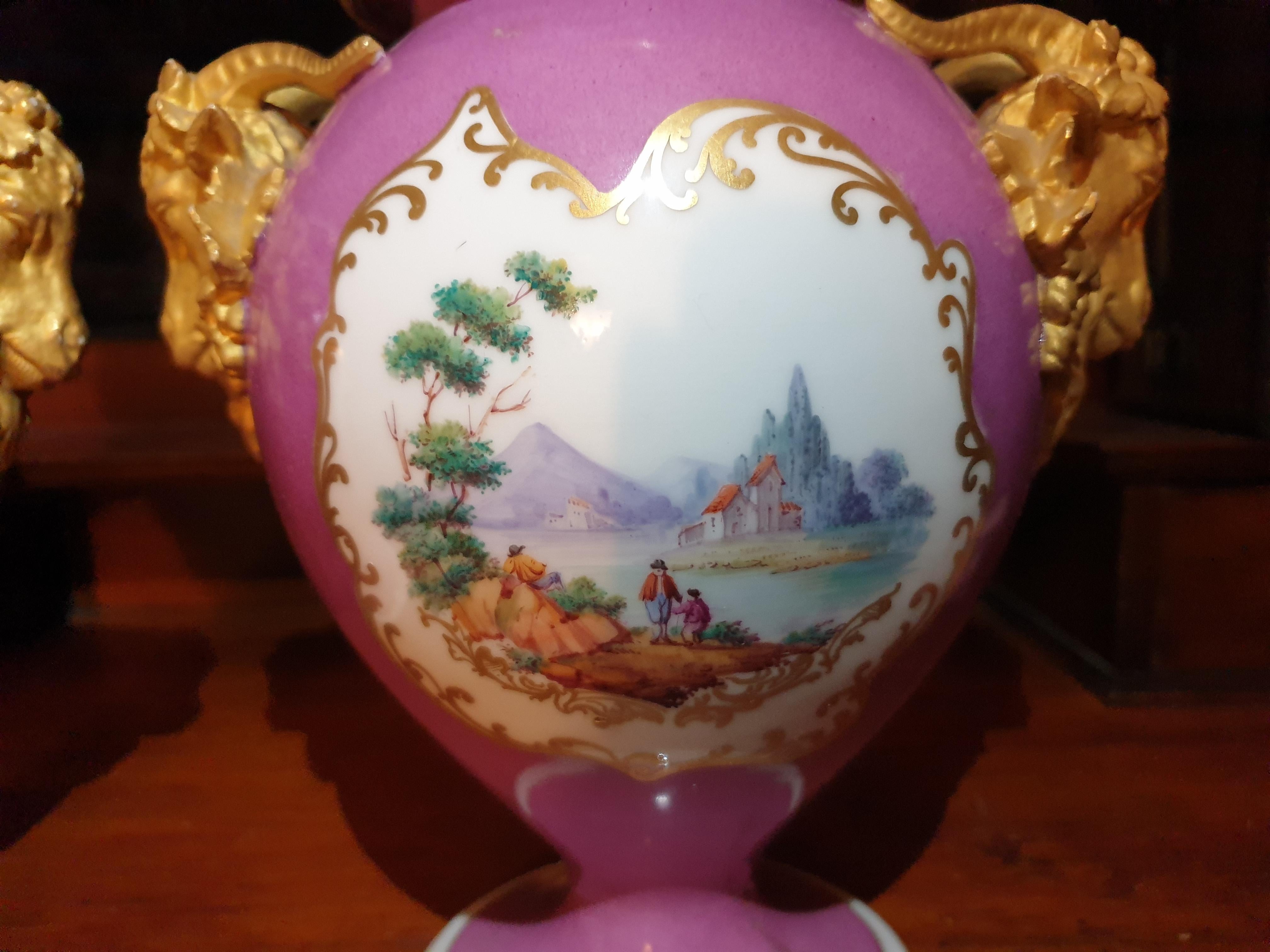 A unique pair of 24k gilt golden Staffordshire made ram handled pink plump vases. Hand painted with scenes on either side with heavy gilding on the vases, fine quality pair of vases that dates from 1850's in perfect condition.