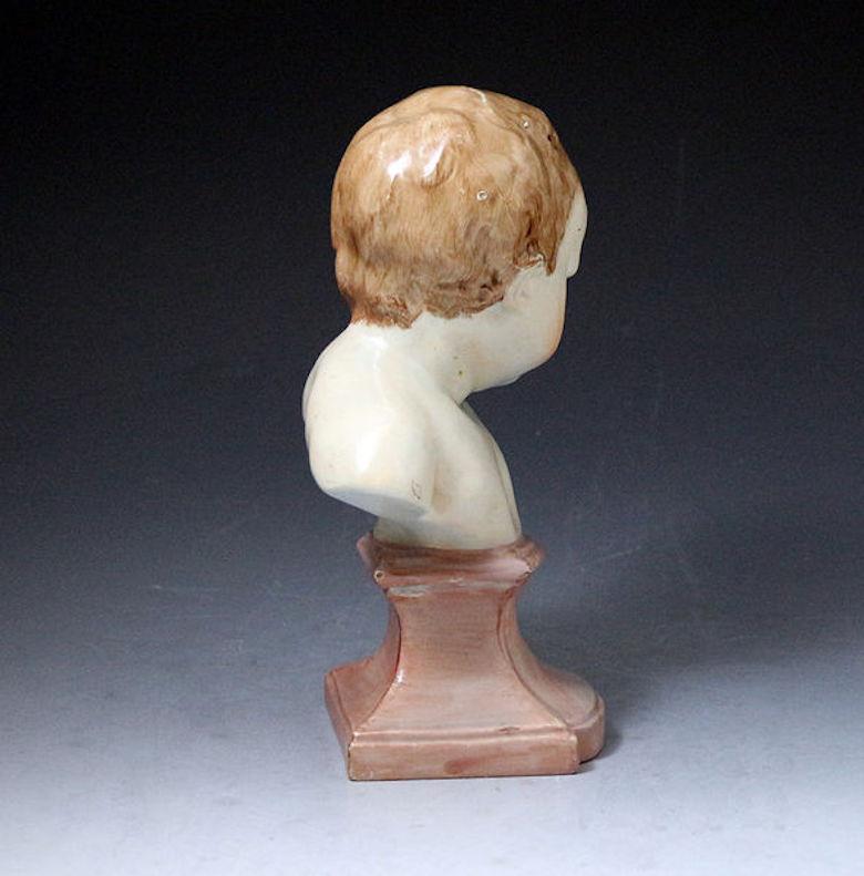 Staffordshire pearlware pottery bust of a putto with a socle base. The modeling is very expressive and the restrained enamel decoration expresses an innocent tenderness.

Dimensions: 5.00 inch wide, 9.00 inch high, 4.00 inch deep

Medium: