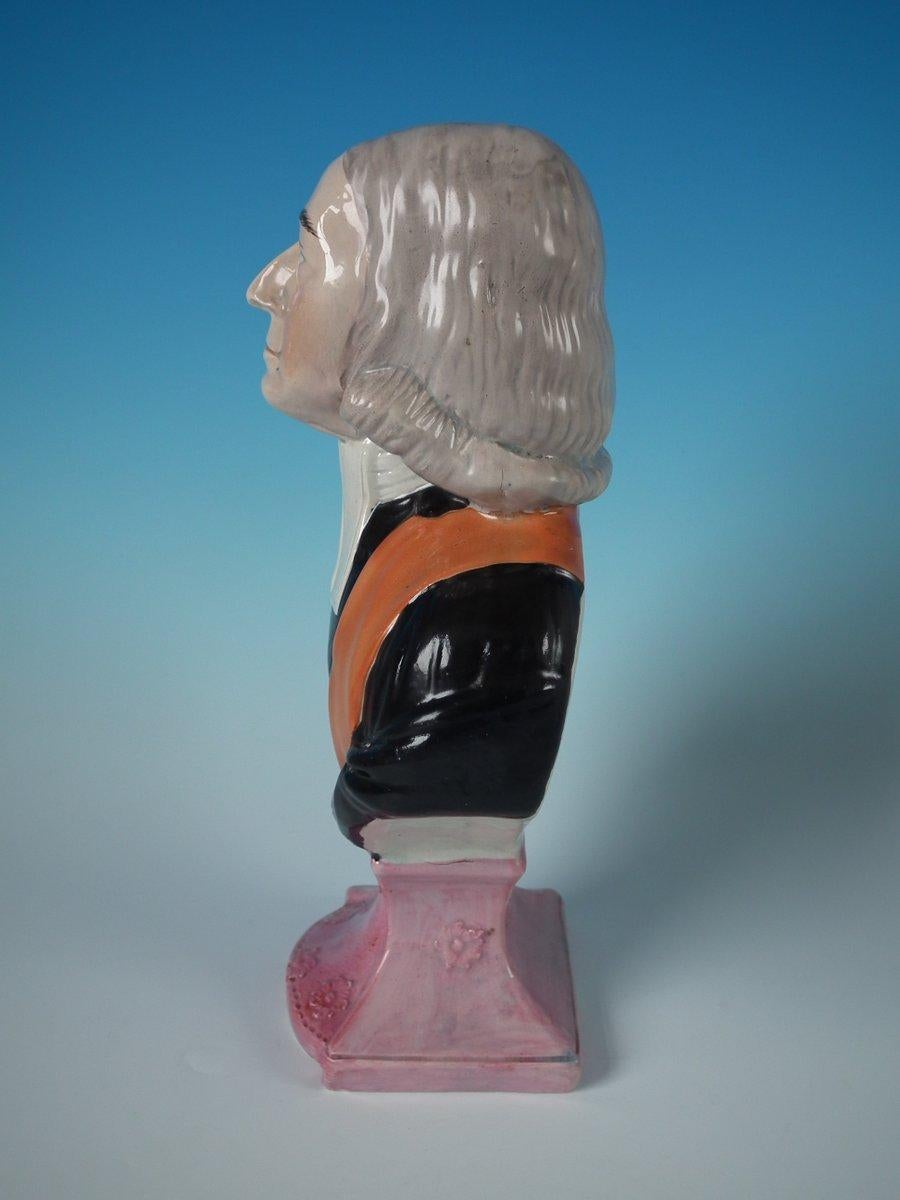 Staffordshire pottery pearlware bust with a religious theme which features John Wesley, resting on a plinth base. Multi-colored version. Decorated 'in the round' - decoration to front and reverse. Open bottomed.