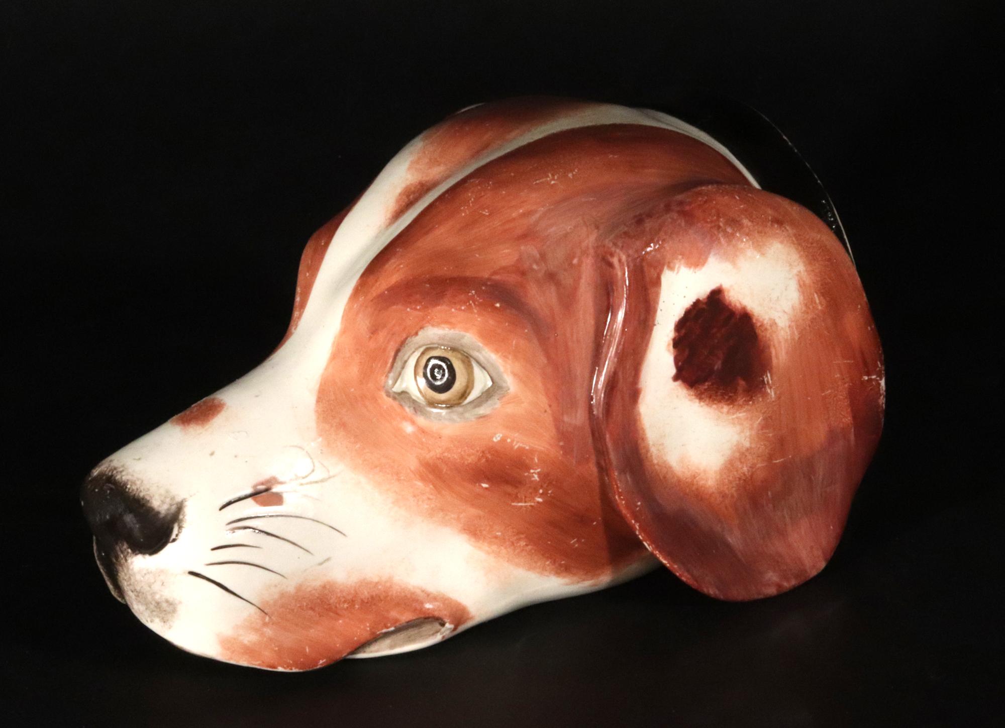 Staffordshire Pearlware Pottery Large Fox Stirrup Cup,
Circa 1820

The large pearlware pottery stirrup cup depicts a fox hound.  The hound is naturalistically colored in browns and white with a few red spots with a black nose, whiskers and collar. 