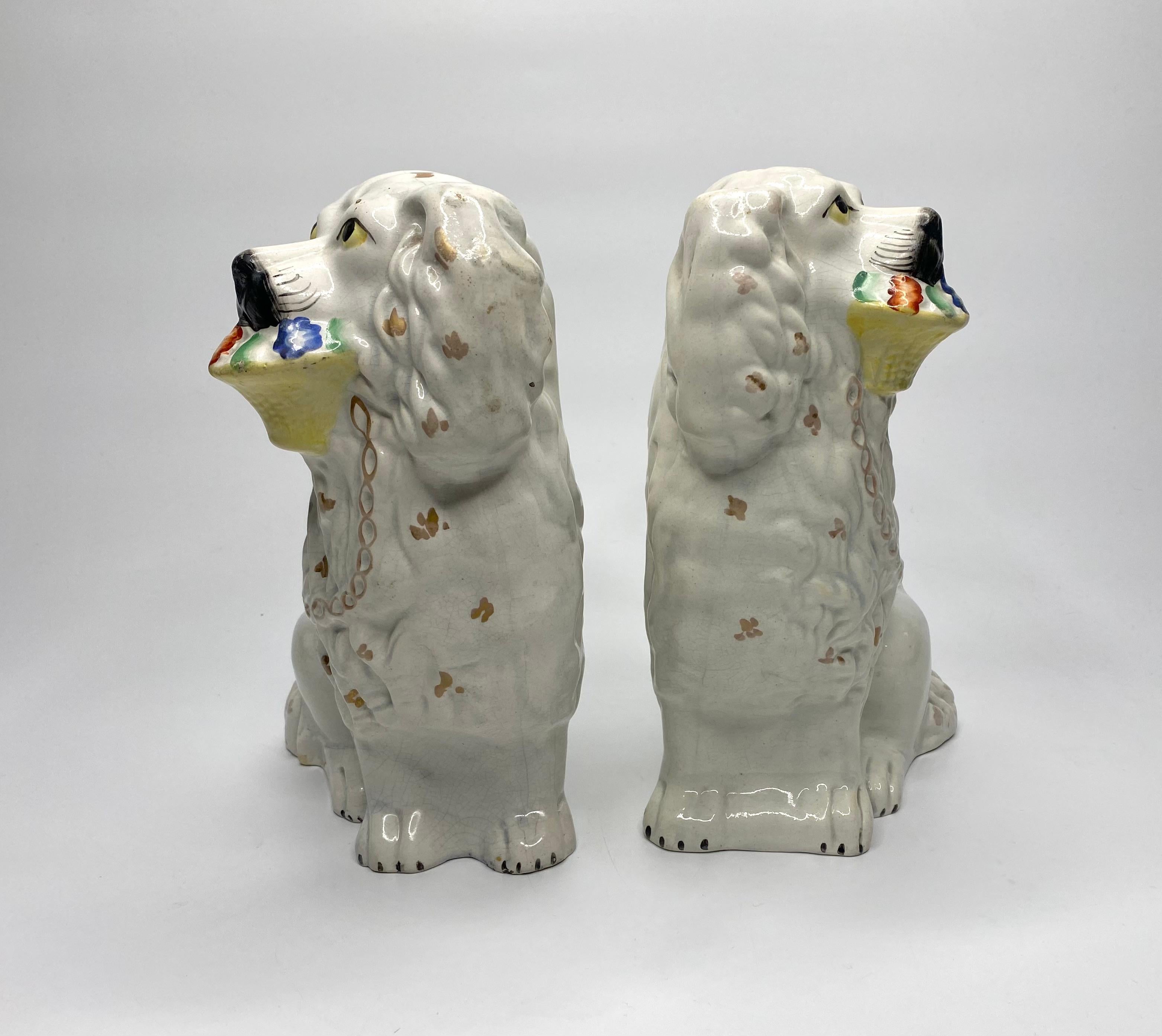 A rare pair of Staffordshire pottery Basket of Flowers Little Lion Dogs, c. 1860. Both dogs seated and moulded with gilt spotted manes. They both have moulded gilt chains, and carry a brightly enamelled basket of flowers in their mouths.
Height – 24