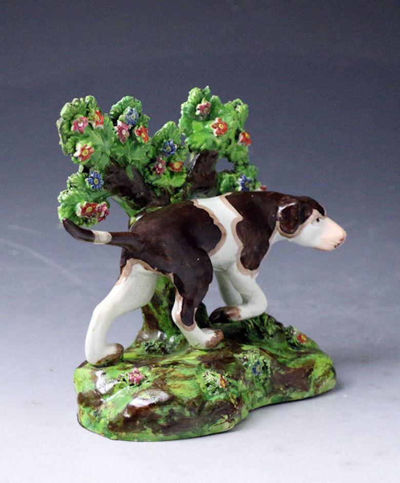 Staffordshire pottery bocage figure of a pointer dog standing on a base. Early 19th century. Staffordshire England, 1820. 

An excellent Staffordshire pottery bocage figure of a pointer gun dog modeled in crouching stance capturing the real