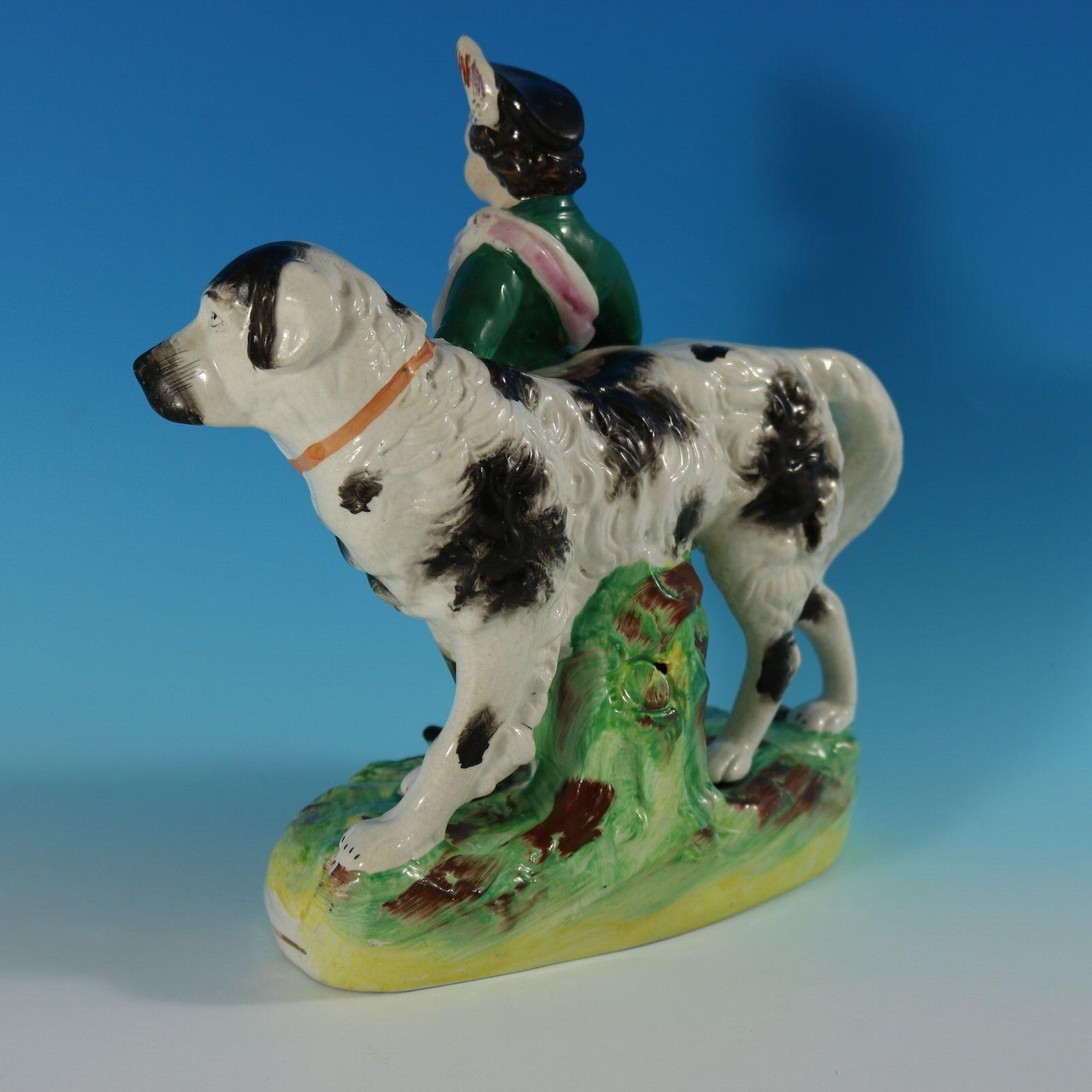 Parr Factory Staffordshire figure with a childhood theme which features a boy, standing in front of a St. Bernard dog, stood on an oval base. Dull gilt base line and embellishment. Decorated 'in the round' - decoration to front and reverse. Vent