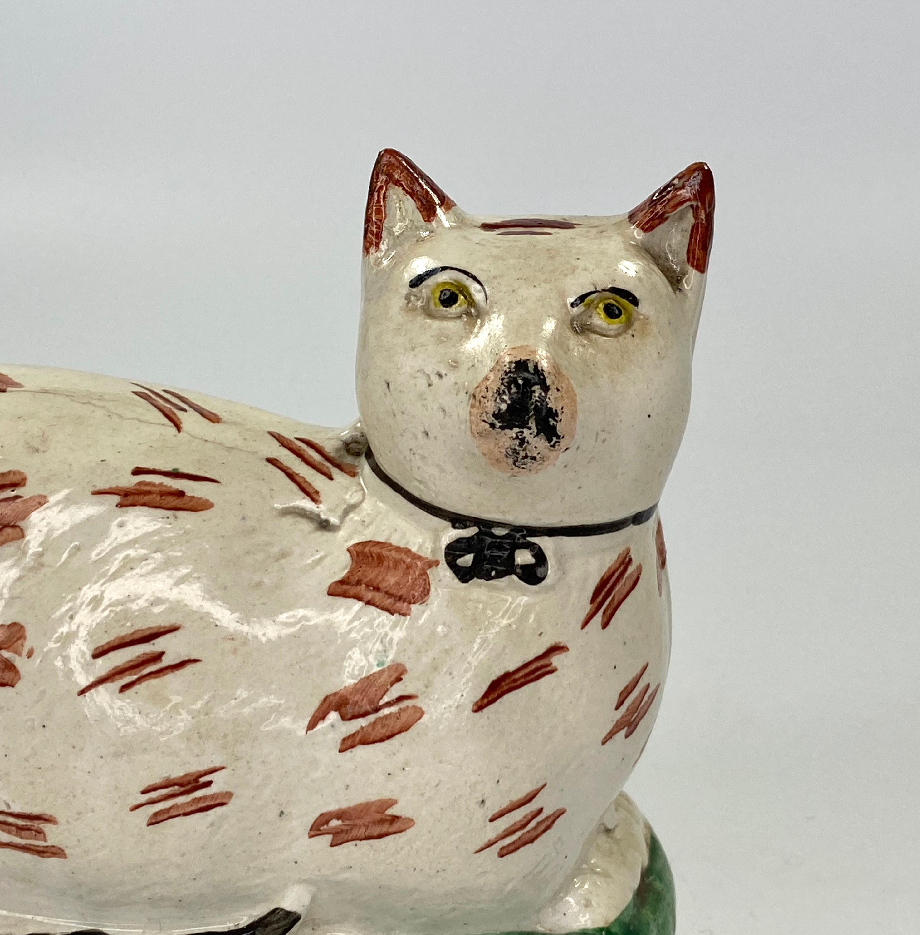 £580.00
Staffordshire pottery figure, circa 1860. Modelled as a recumbent cat, upon an oval mound base. The cat having yellow eyes and brown colouring to it’s coat, lying upon a grassy base.
Medium: Earthenware.
Measures: Height 12.7 cm,