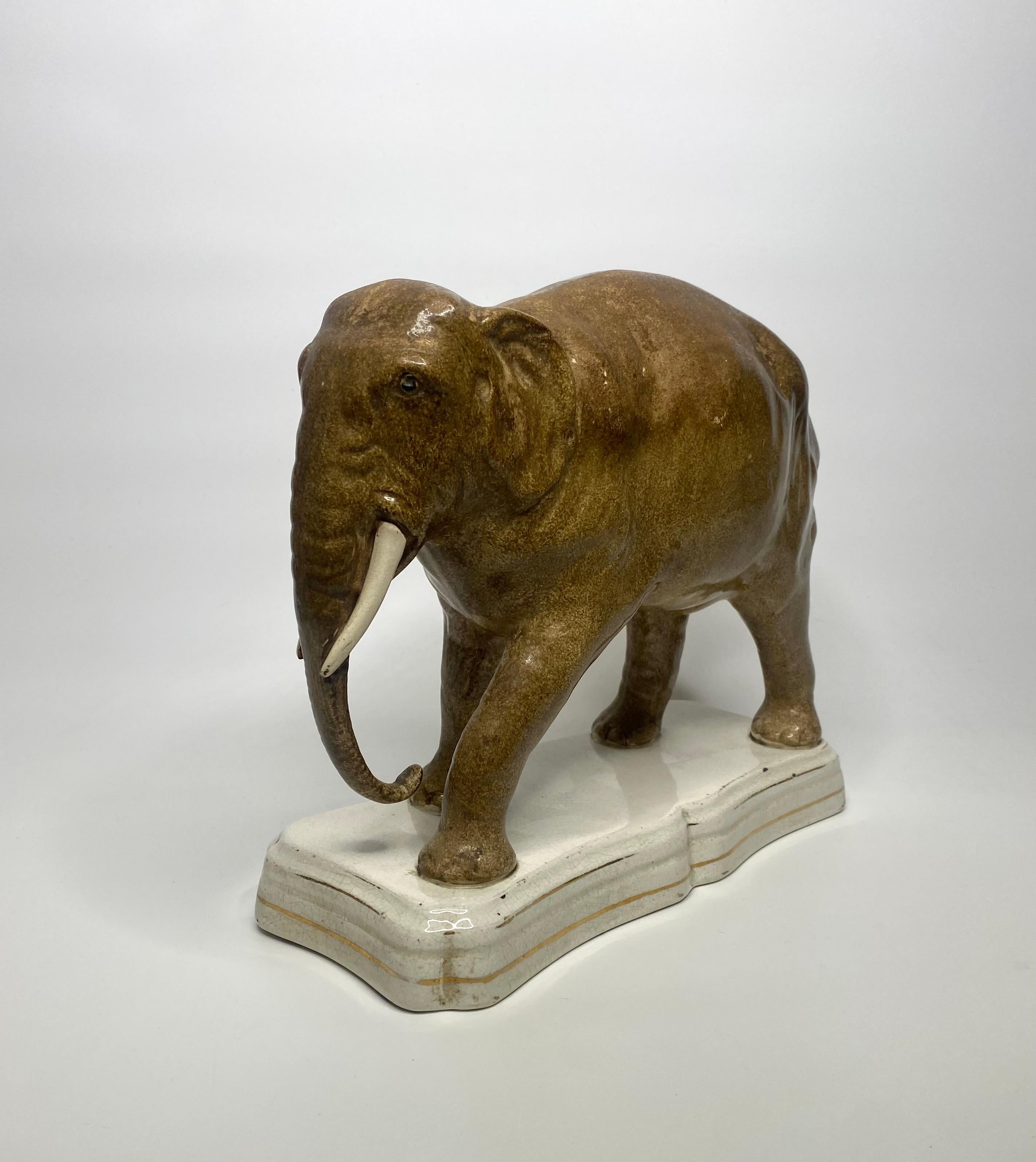 Large Staffordshire pottery elephant, ‘Jumbo’, c. 1860. The famous circus elephant, well modelled in the round, and naturistically coloured.
Set upon a shaped rectangular base, and having gilt lines to the base.
Length – 29.8 cm, 11 3/4”.
Height –