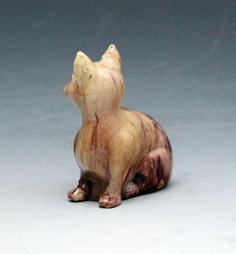 Dated: 1760 Staffordshire England

A mid-18th century pottery figure of a seated cat decorated with brown oxide colored glazes in the Thomas Whieldon fashion. The figure is hollow based and though naively made features good detail around the eyes,