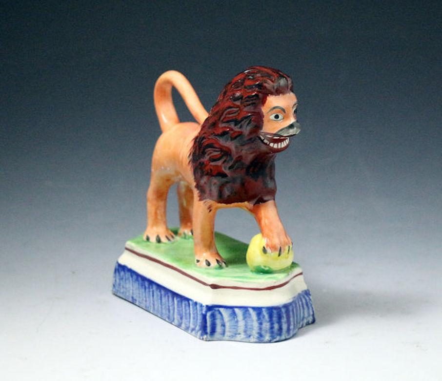 Staffordshire Pottery Figure of a Lion with a Pearlware Glaze Early 19th Century In Good Condition In Woodstock, OXFORDSHIRE