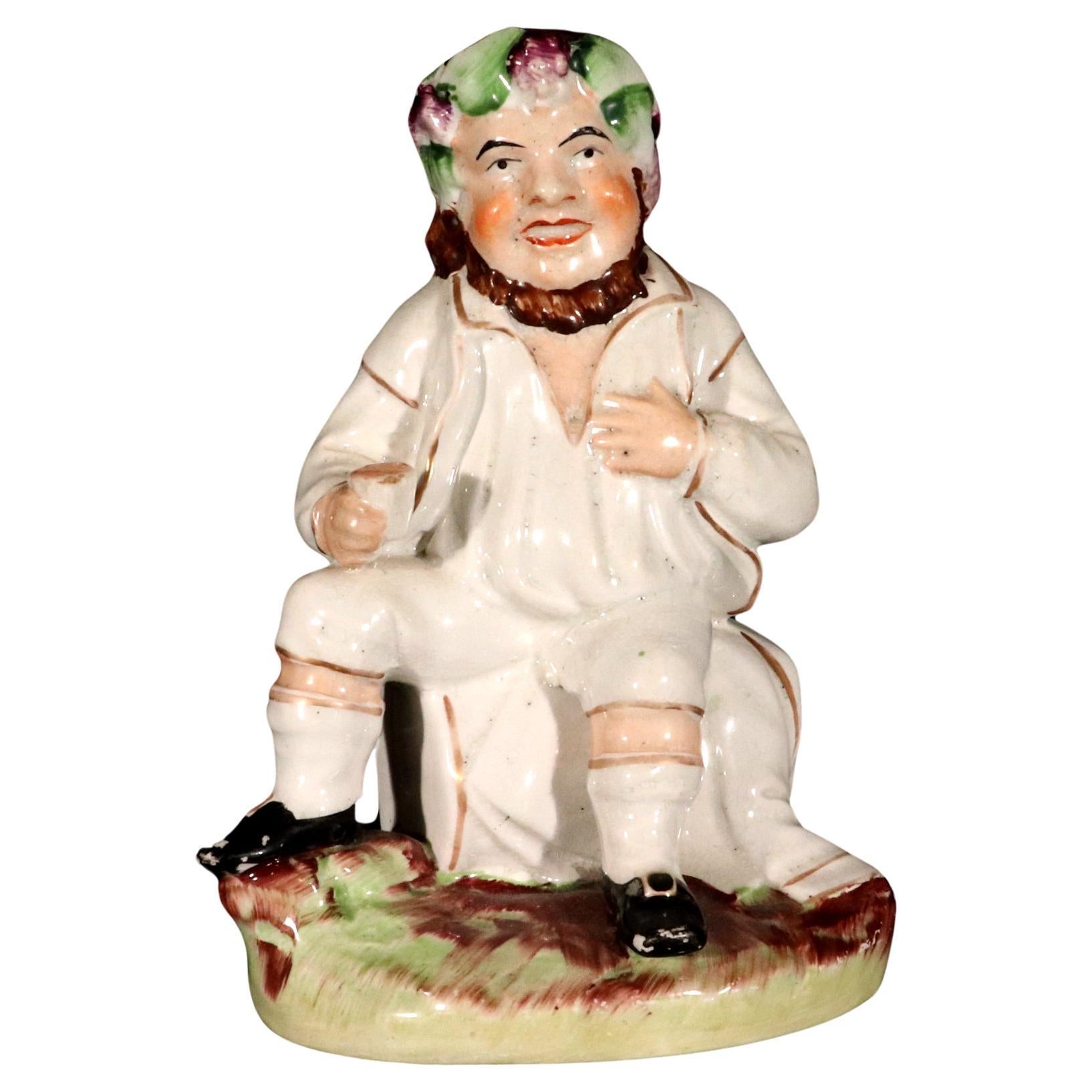 Figure de Bacchus avec une tasse sur un tonneau de vin du Staffordshire en vente