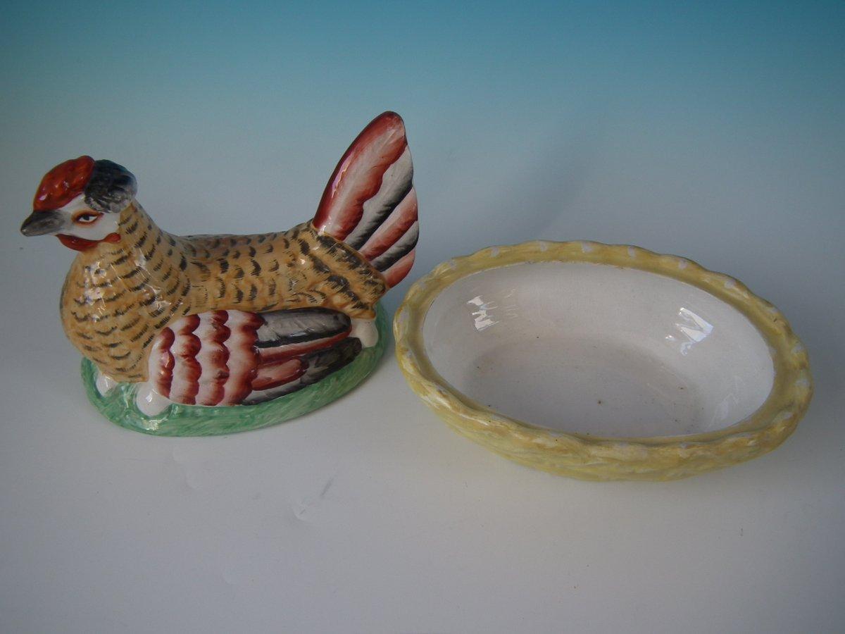 Staffordshire Pottery egg tureen and cover which features a hen, resting on a basketweave oval base. Decorated 'in the round' - decoration to front and reverse. Book reference, 'Victorian Staffordshire figures 1835-1875' Book 2, by A.& N. Harding,