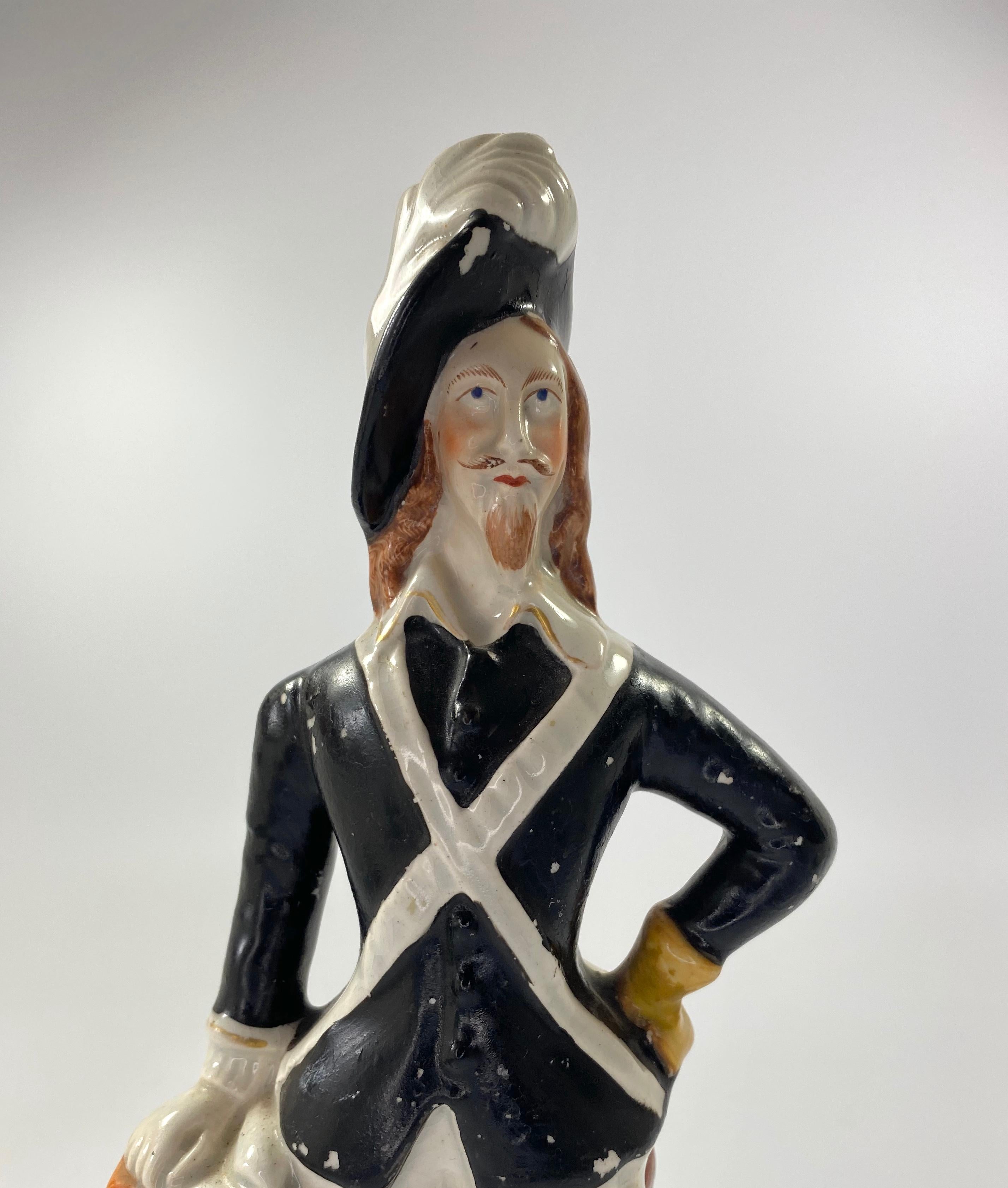 SOLD
Staffordshire pottery figure of King Charles I, Thomas Parr factory, c. 1860. The King, wearing a plumed hat, and standing next to a square pedestal, upon which rests a scroll. His sword resting against the support, behind him. Set upon a