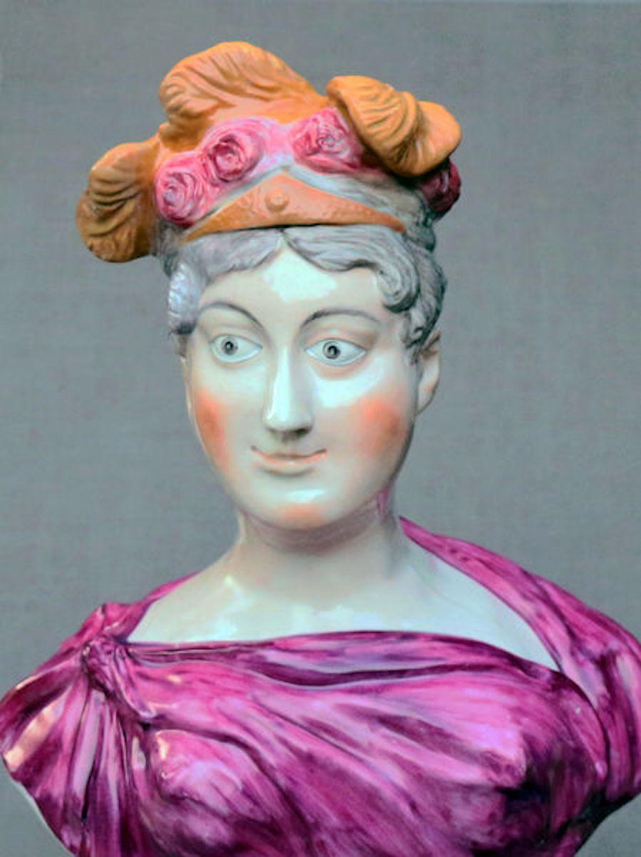 Dated: c. 1815 Staffordshire England

A large very rare and impressive pearlware Staffordshire pottery bust of Princess Charlotte modeled on a socle base. Although the bust is made in the classical form the naive painting and bold rendition of