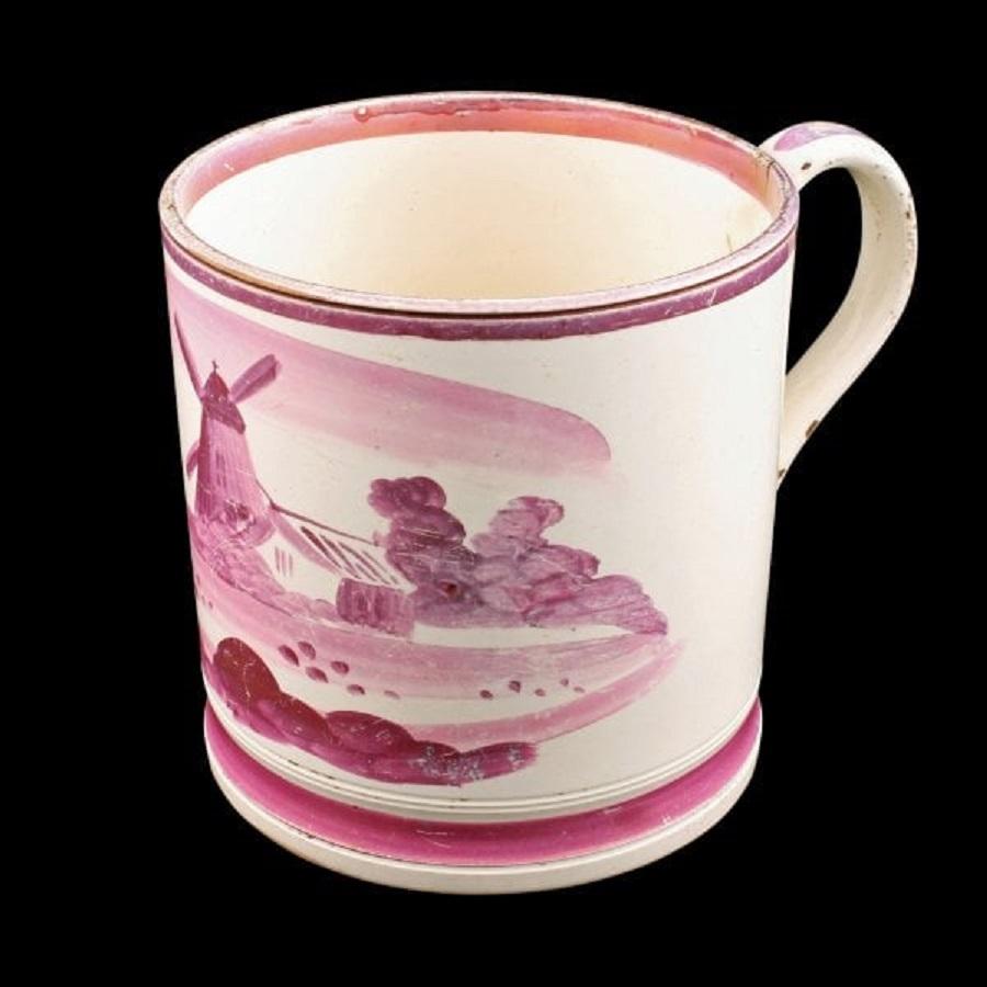 An early 19th century Staffordshire pottery tankard.

The tankard has a pink lustre decoration of a windmill in a pastoral scene.

The tankard is in good condition, (Circa 1830)

Measures: Height 12.2cm (4.8 inches)
Width 16cm (6.3