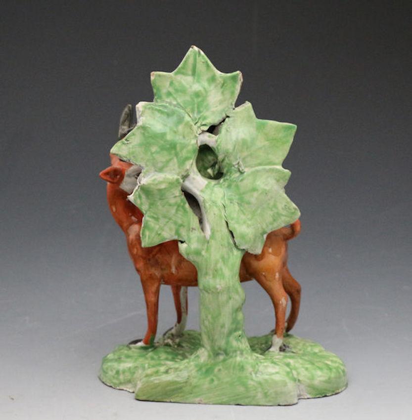 An exceptionally rare pottery pearlware figure of a stag with colorful bocage. The bocage type is probably unique to this figure and is one of the rarest forms. Retains the label of dealer Jonathan Horne London.

Dimensions: 6.00 inch wide 8.00